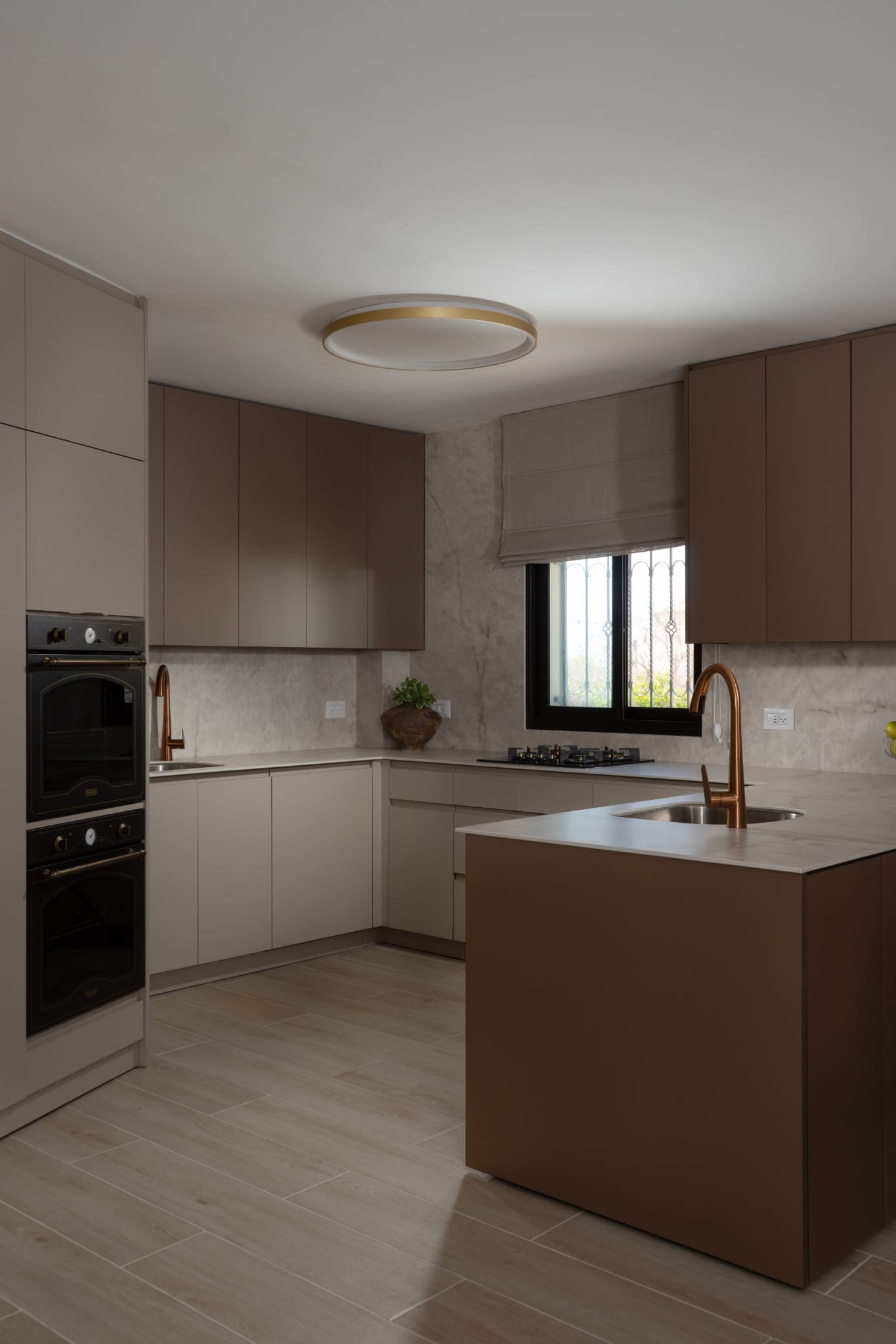 Modern kitchen with brown cabinets and copper fixtures