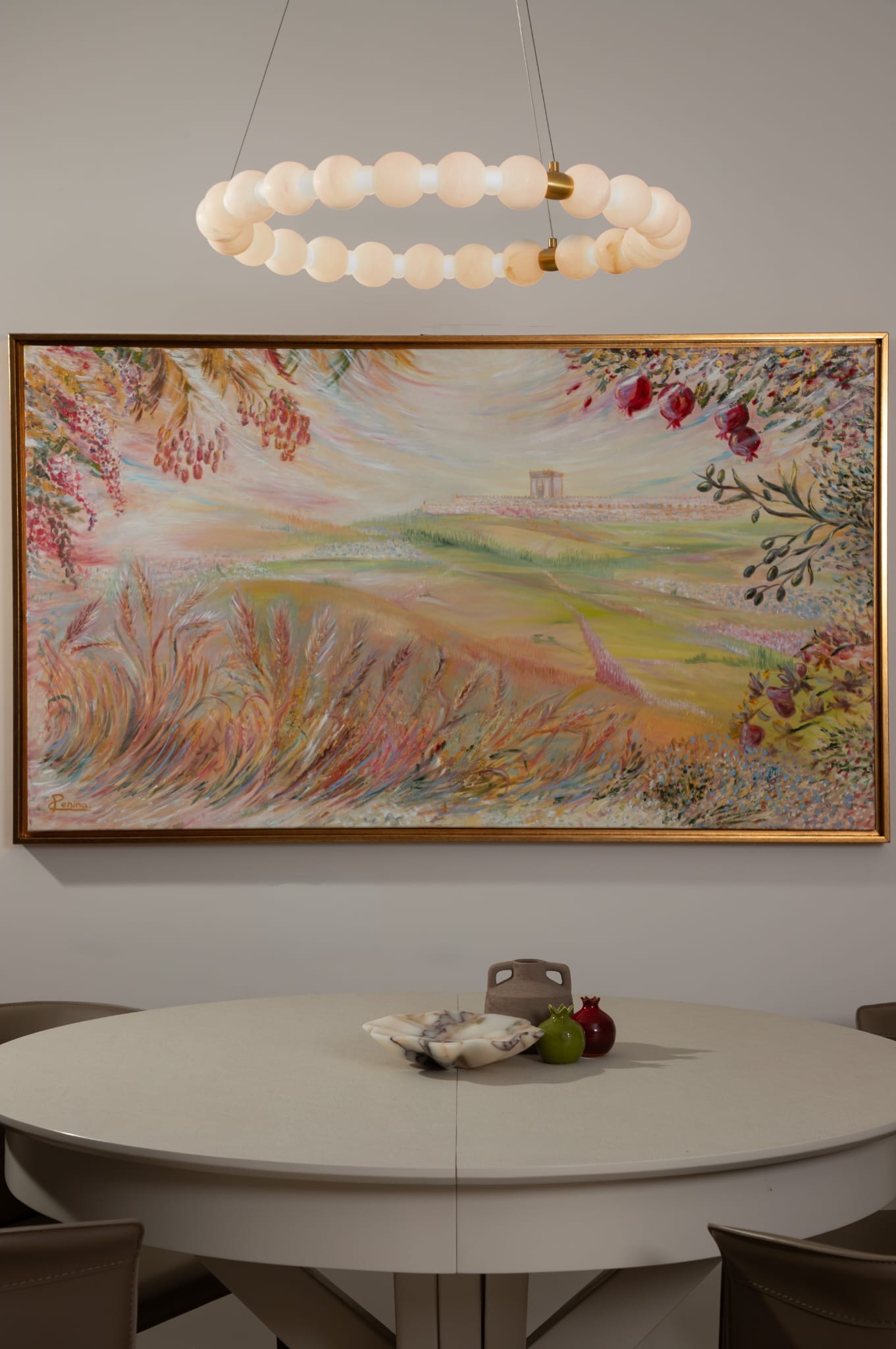 Dining area with round table and large landscape painting
