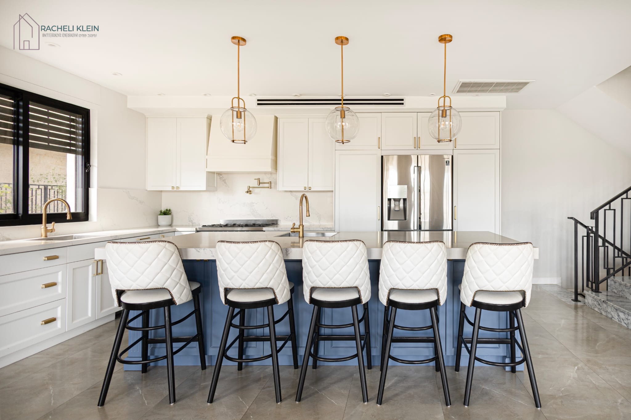 Modern kitchen design with blue island and white bar stools