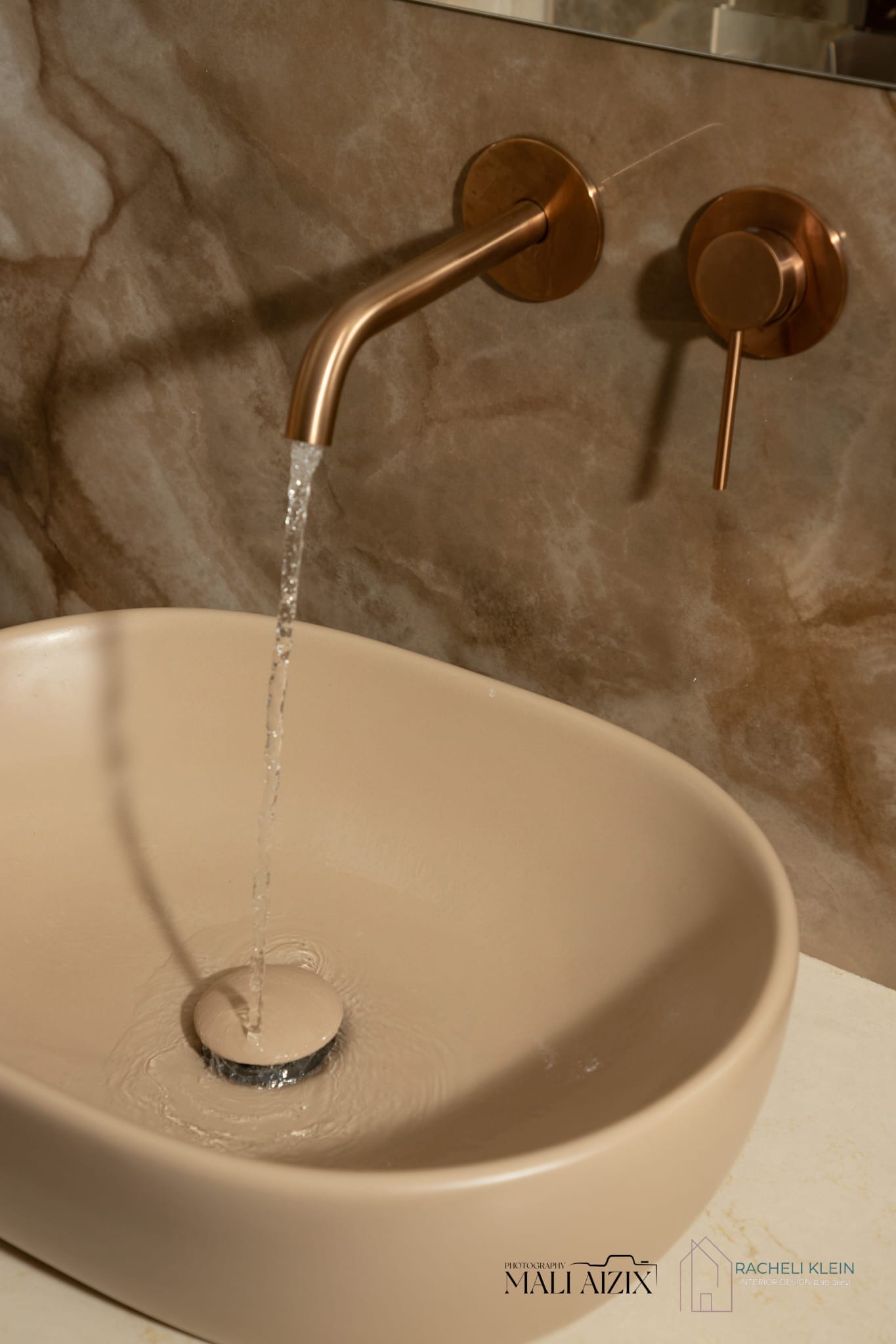 Elegant bathroom sink with copper wall-mounted faucet — bathroom interior design in Bet Shemesh
