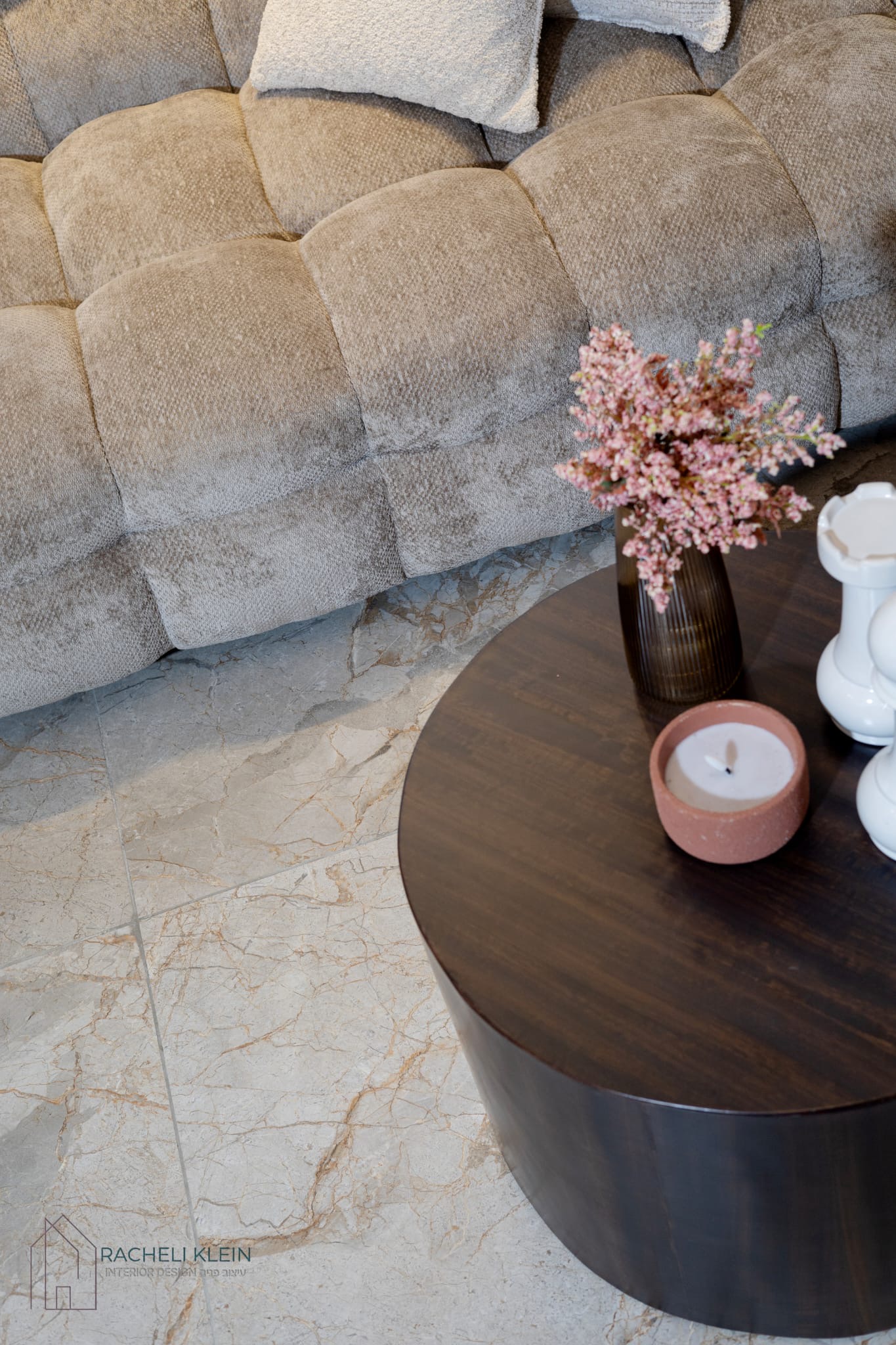 Close-up of textured sofa and round coffee table with decor