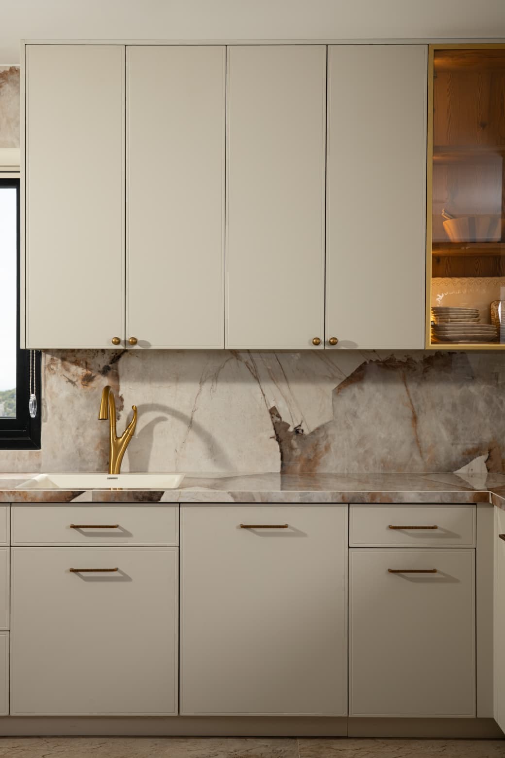 Kitchen with white cabinets and marble backsplash