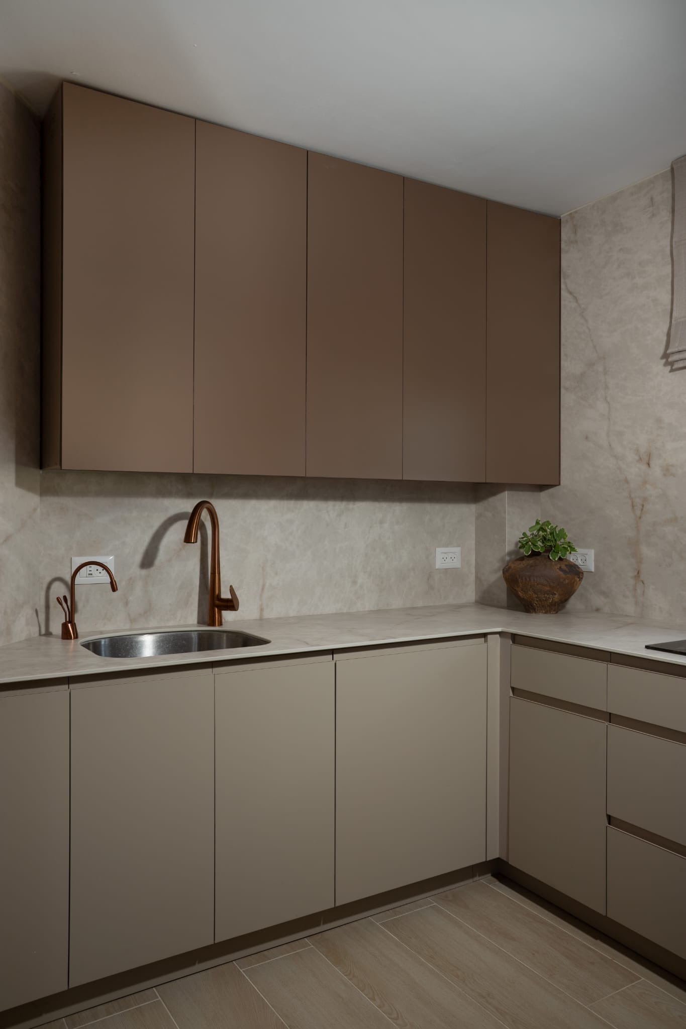 Modern kitchen with brown cabinets and copper faucet