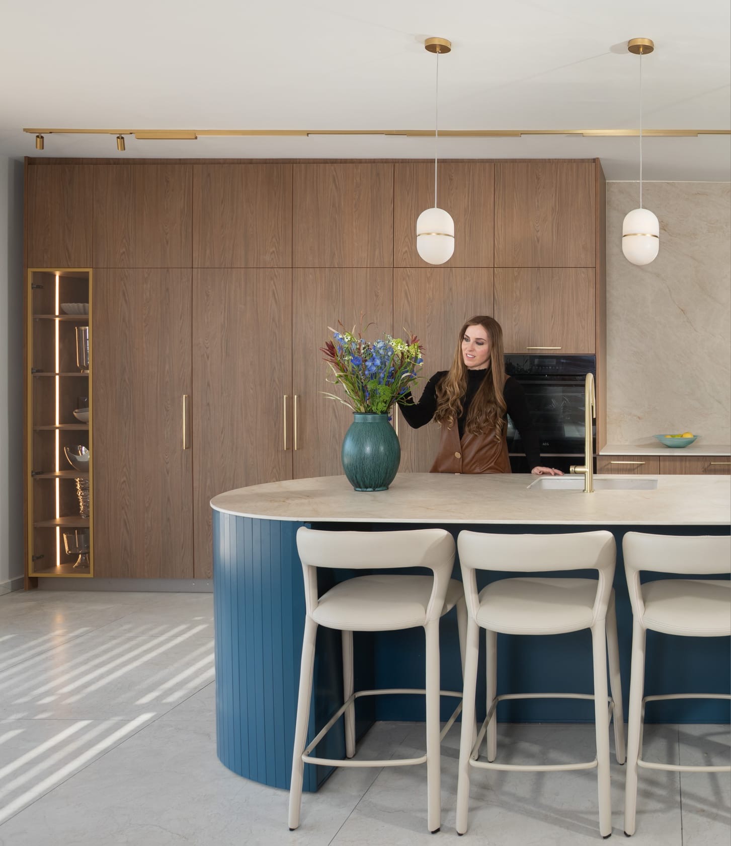 Woman arranging flowers on kitchen island