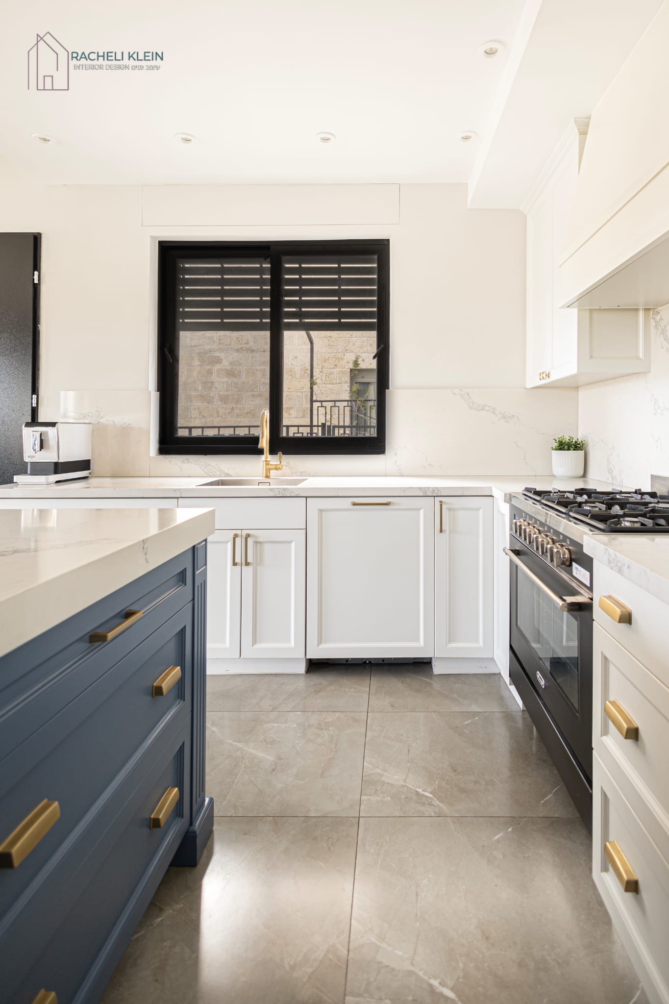 Kitchen with blue island and white cabinets