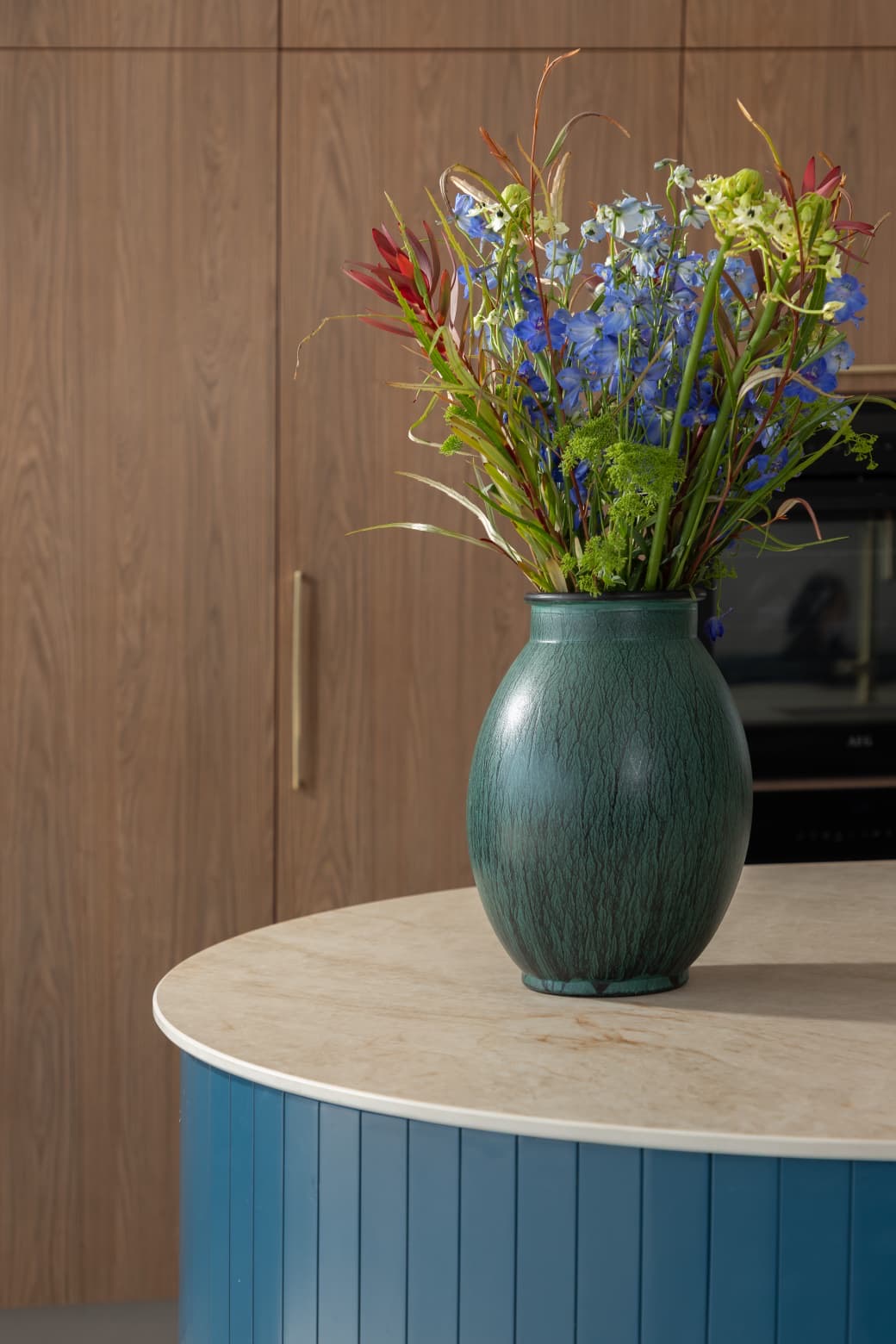 Vase with flowers on kitchen island