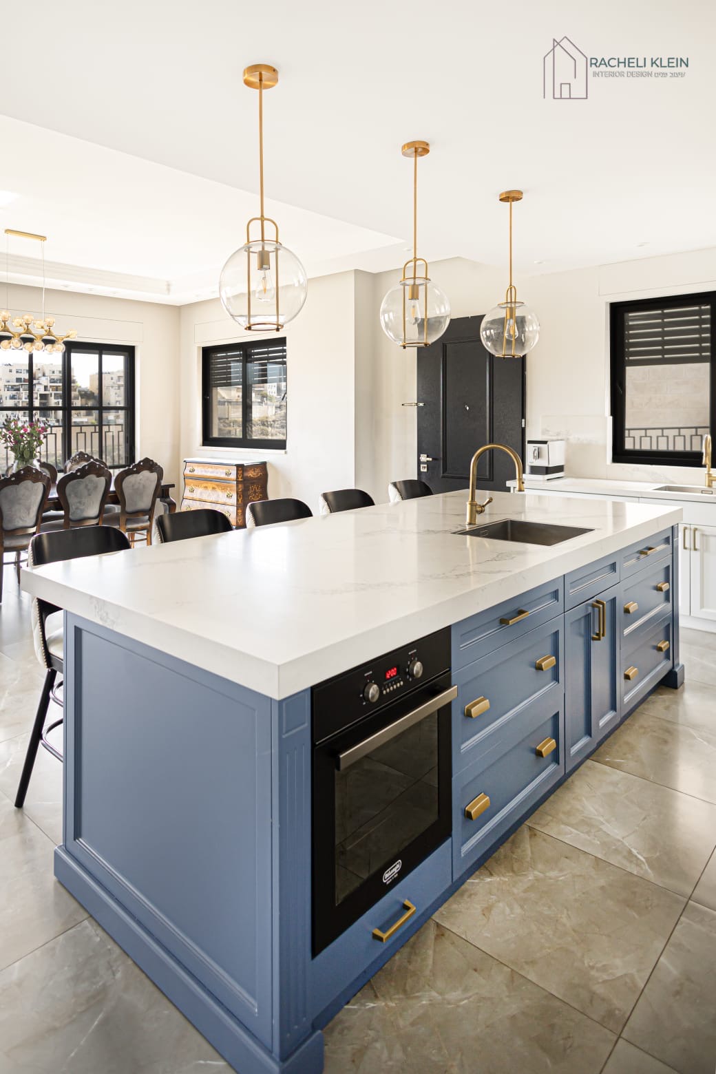 Kitchen with large blue island and dining area