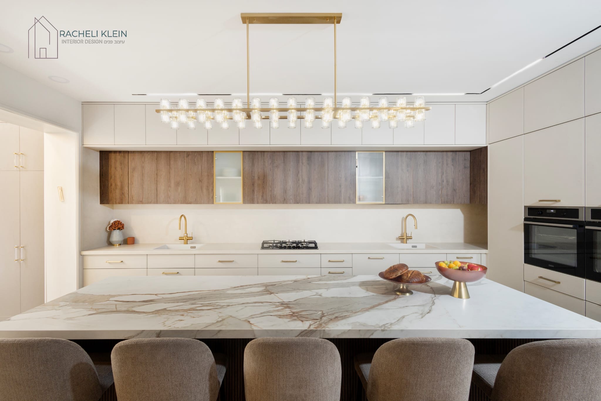 Modern bright kitchen with marble island and elegant lighting