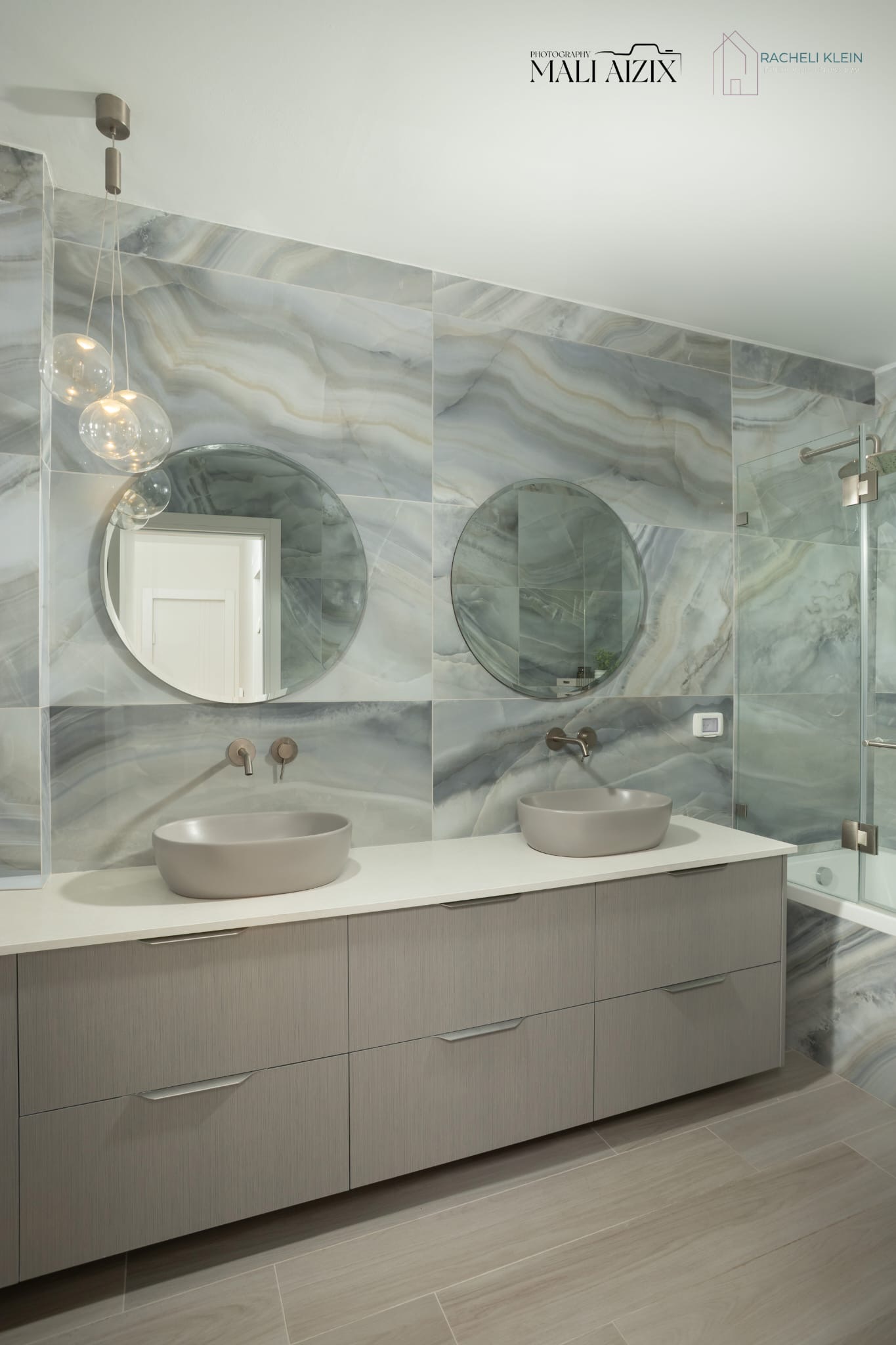 Custom bathroom design in Israel with blue marble tiles and double sinks by Racheli Klein
