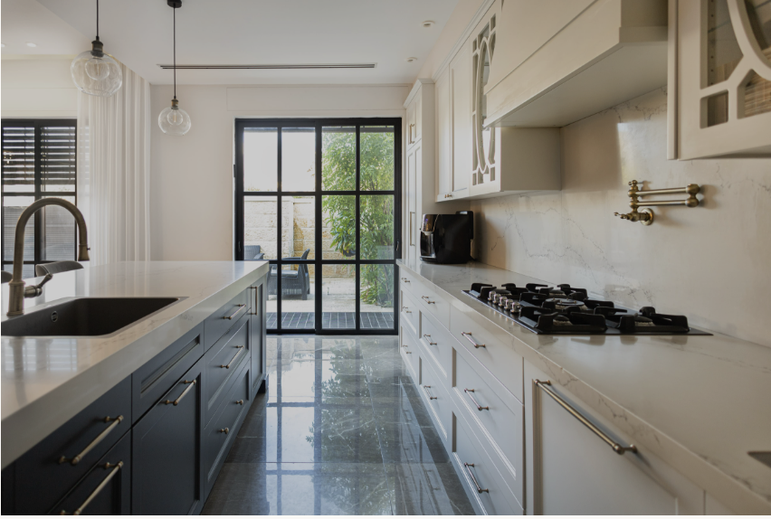 Kitchen with dark island and marble backsplash