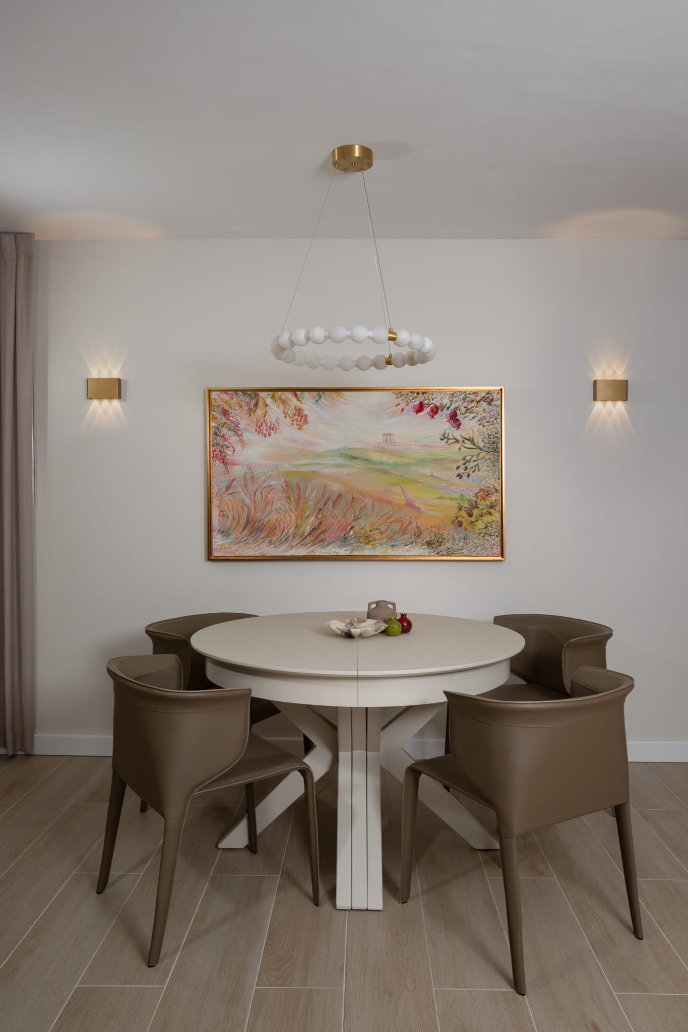 Elegant dining room with modern chandelier and artwork