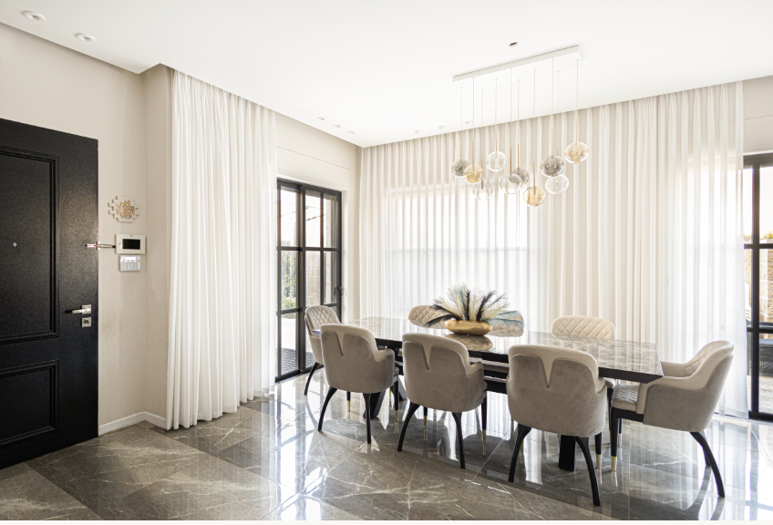 Elegant dining room with large table and modern chandelier