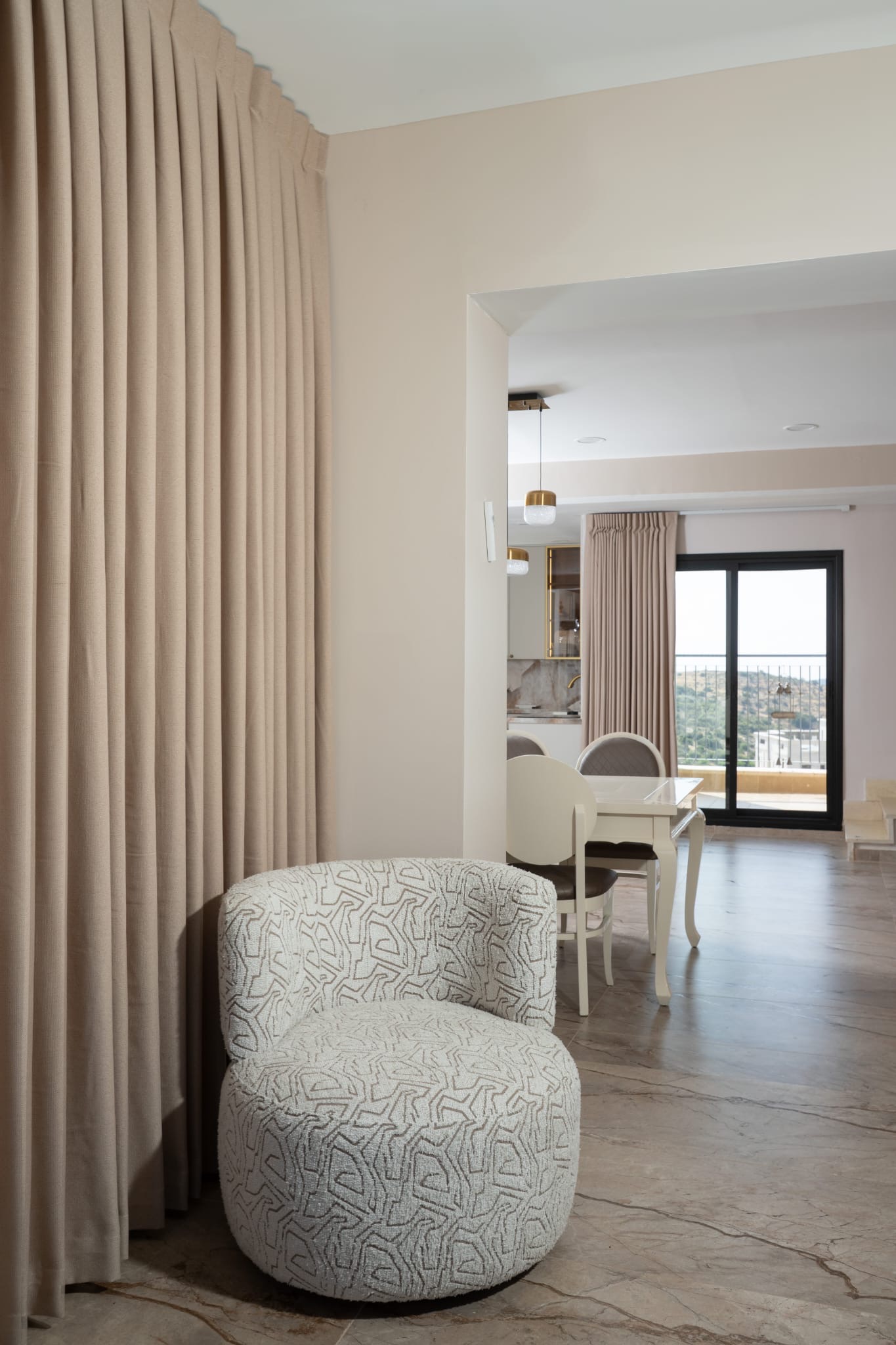 Living space with elegant curtains and patterned armchair