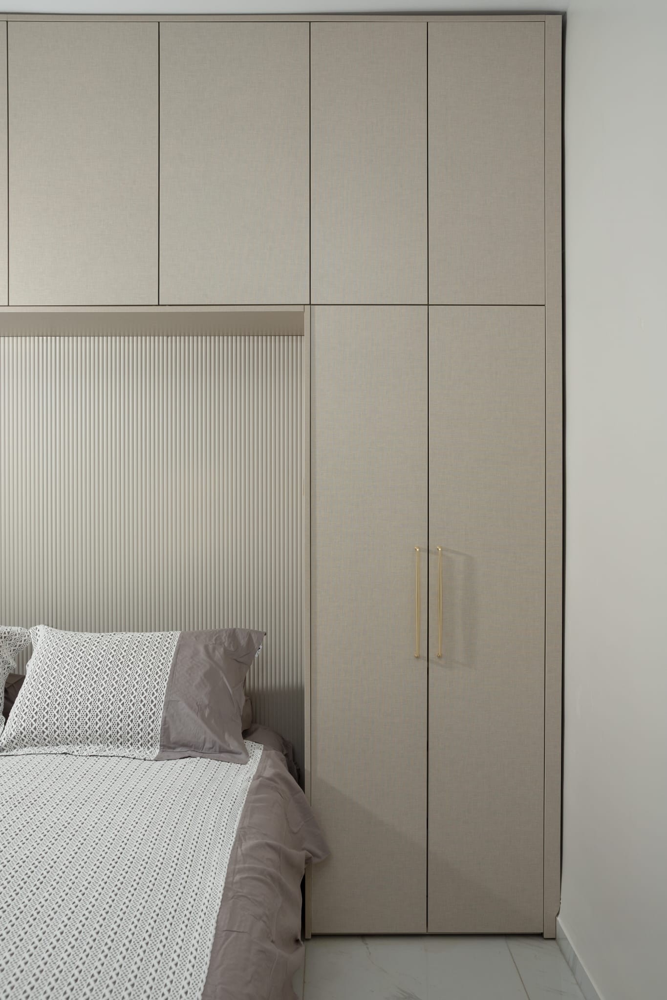 Bedroom wardrobe with textured headboard