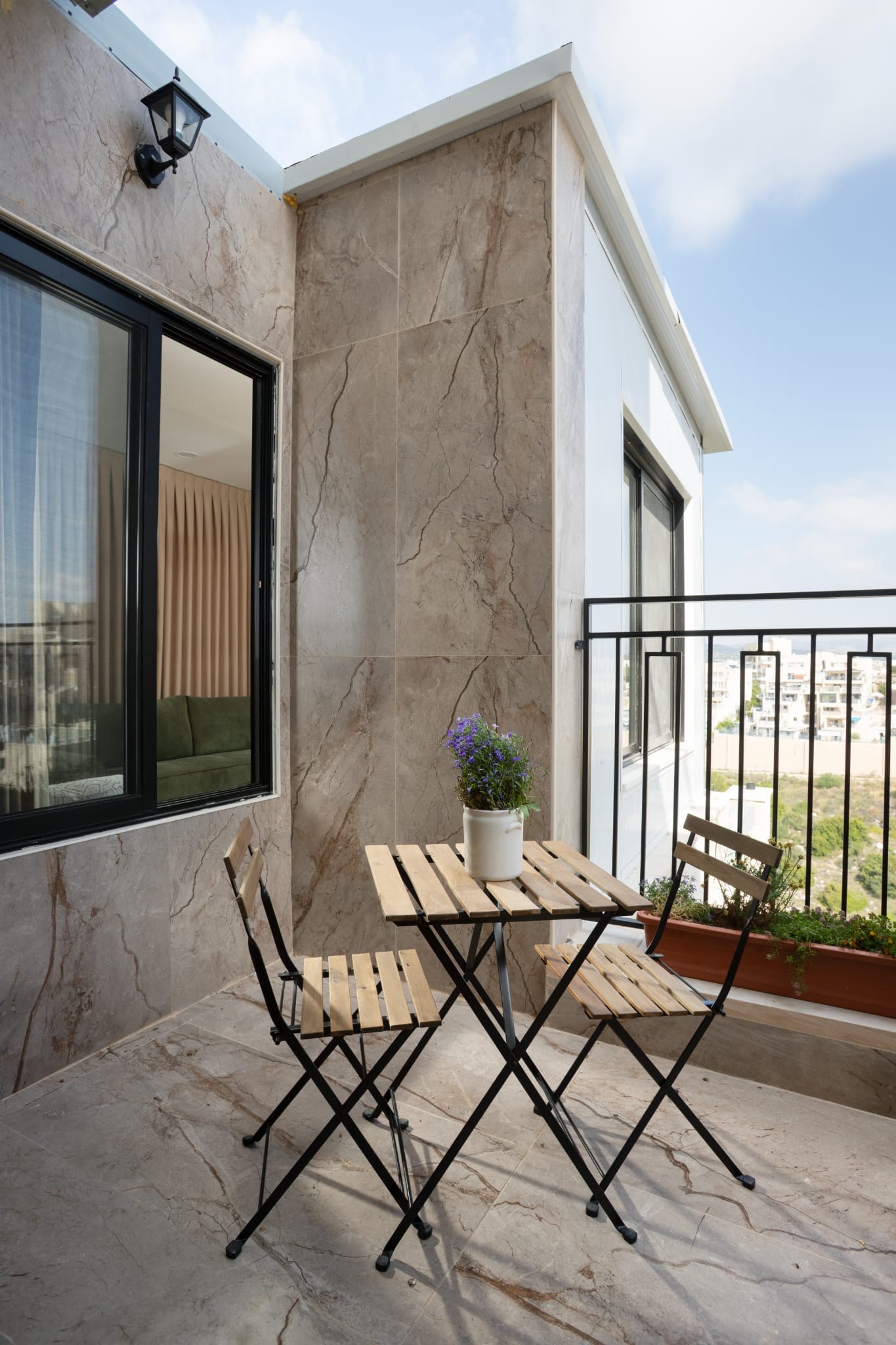 Balcony with small table and chairs