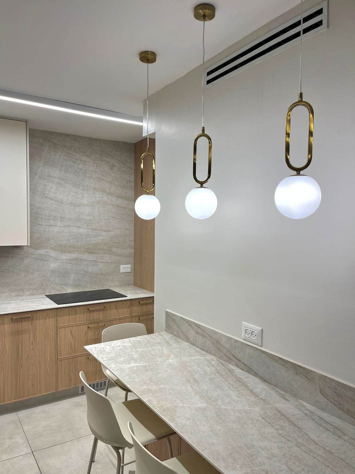 Dining area with marble table and modern globe pendant lights