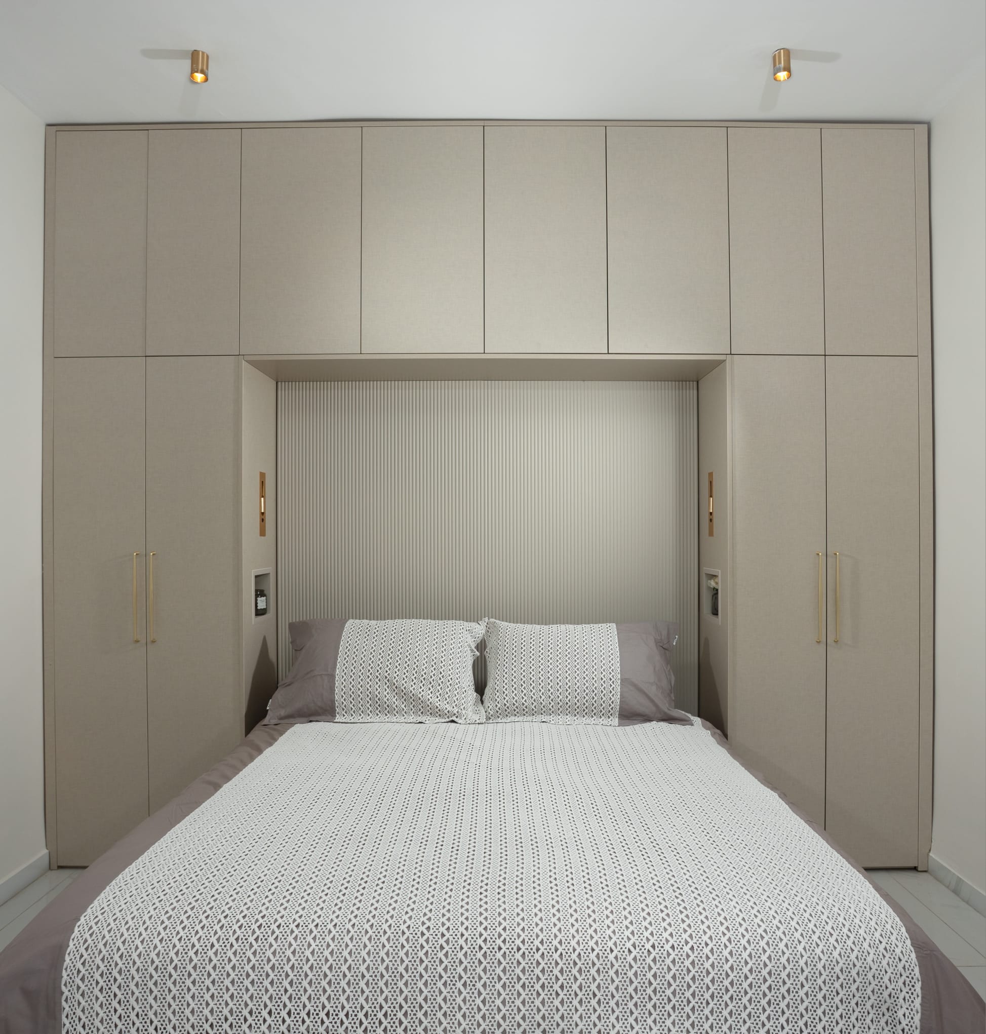 Bedroom with built-in wardrobe around bed