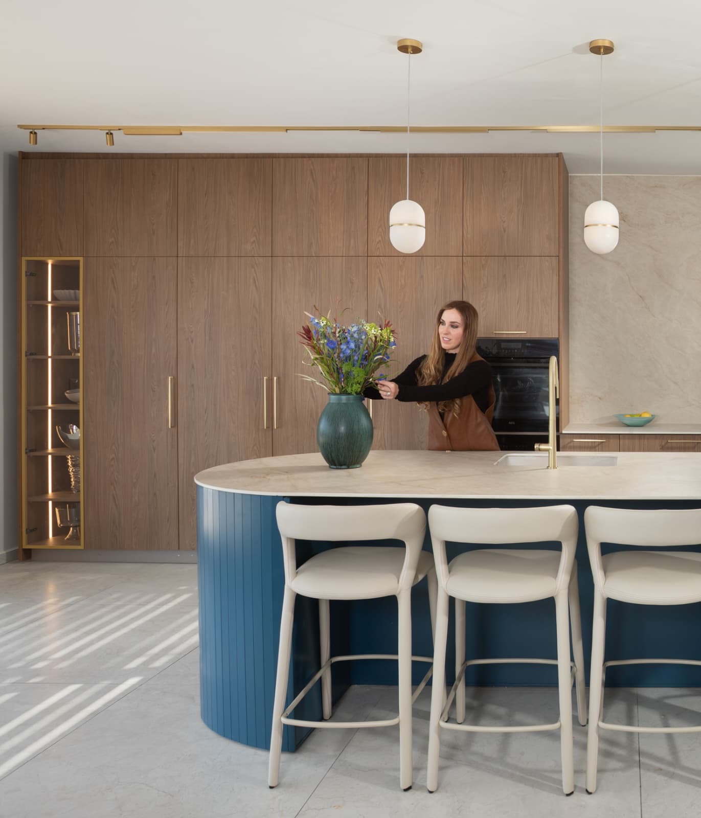 Designer adjusting flowers in kitchen