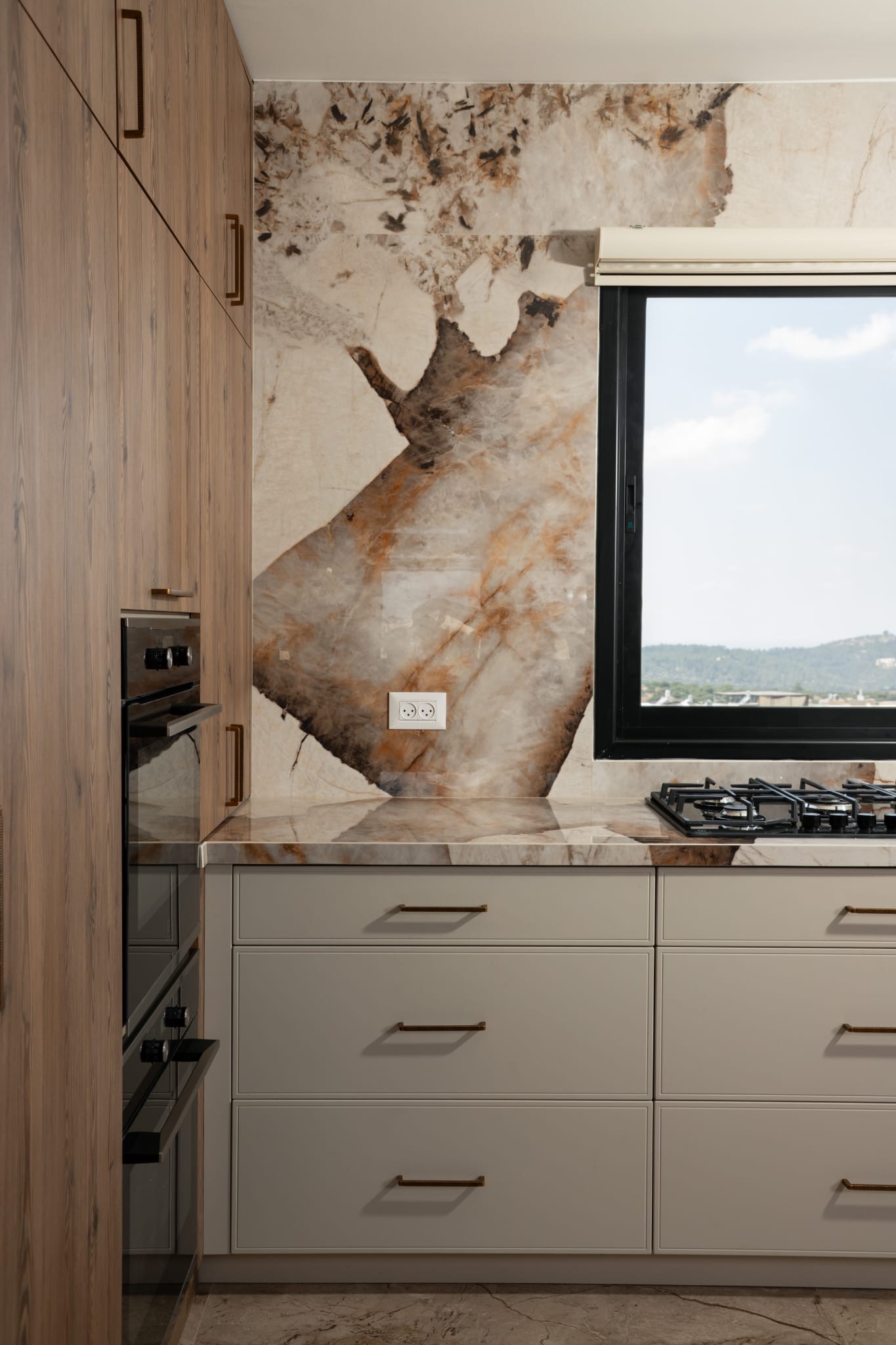 Kitchen with large window and marble backsplash