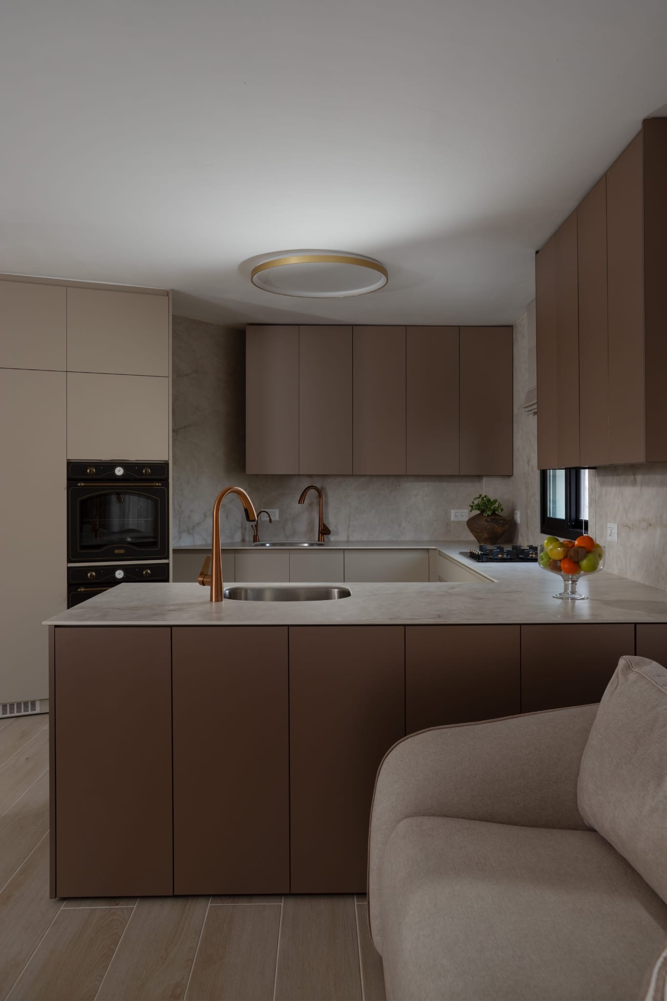 Kitchen with brown cabinets and island