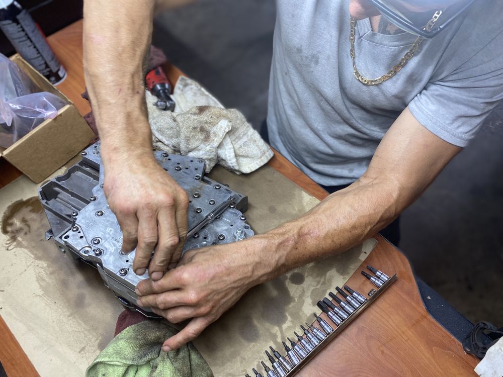 Joe Mercado working on a vehicle transmission
