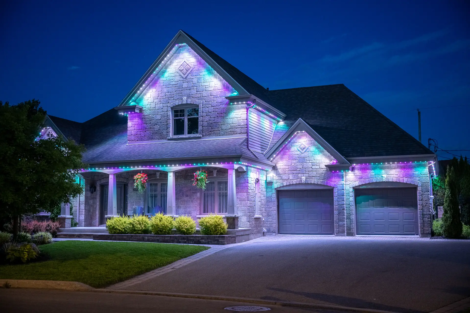 House lit up with warm architectural roofline lighting