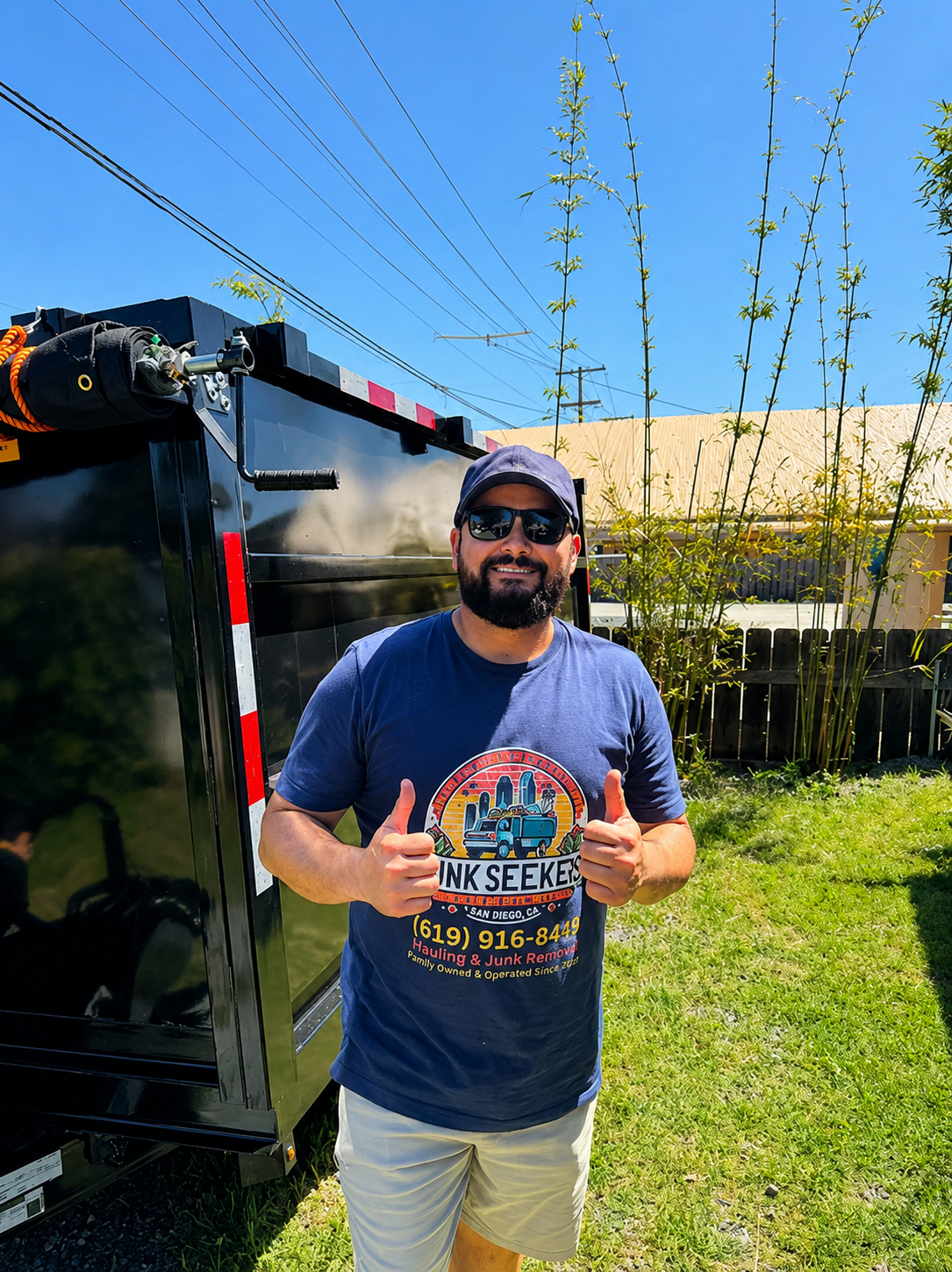 Santiago, owner of Junk Seekers, standing professionally in front of a service vehicle