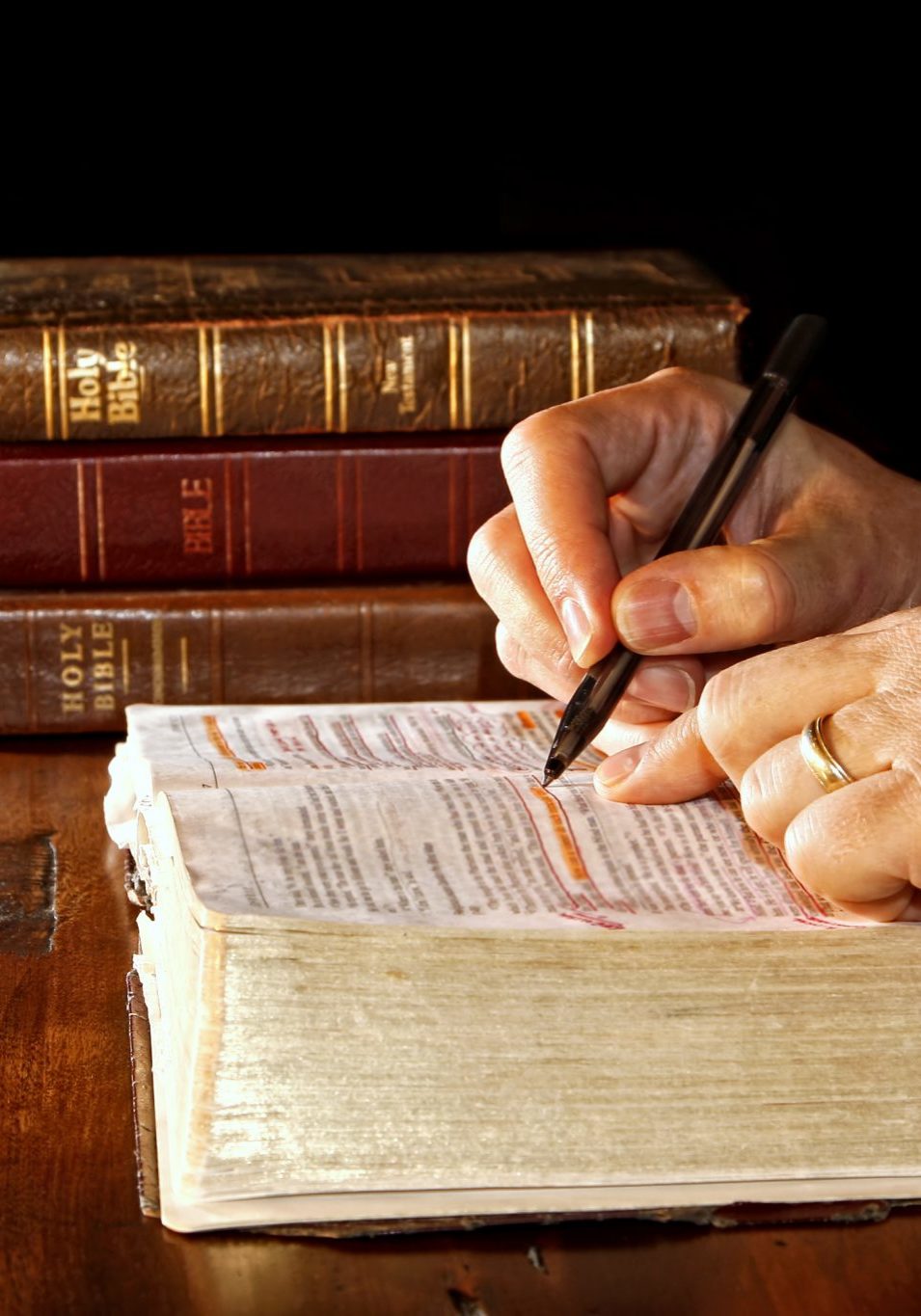 Person writing in a Bible