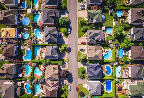 Aerial view of residential structures and neighborhoods in Greater Montreal representing our pre-purchase building inspection coverage area