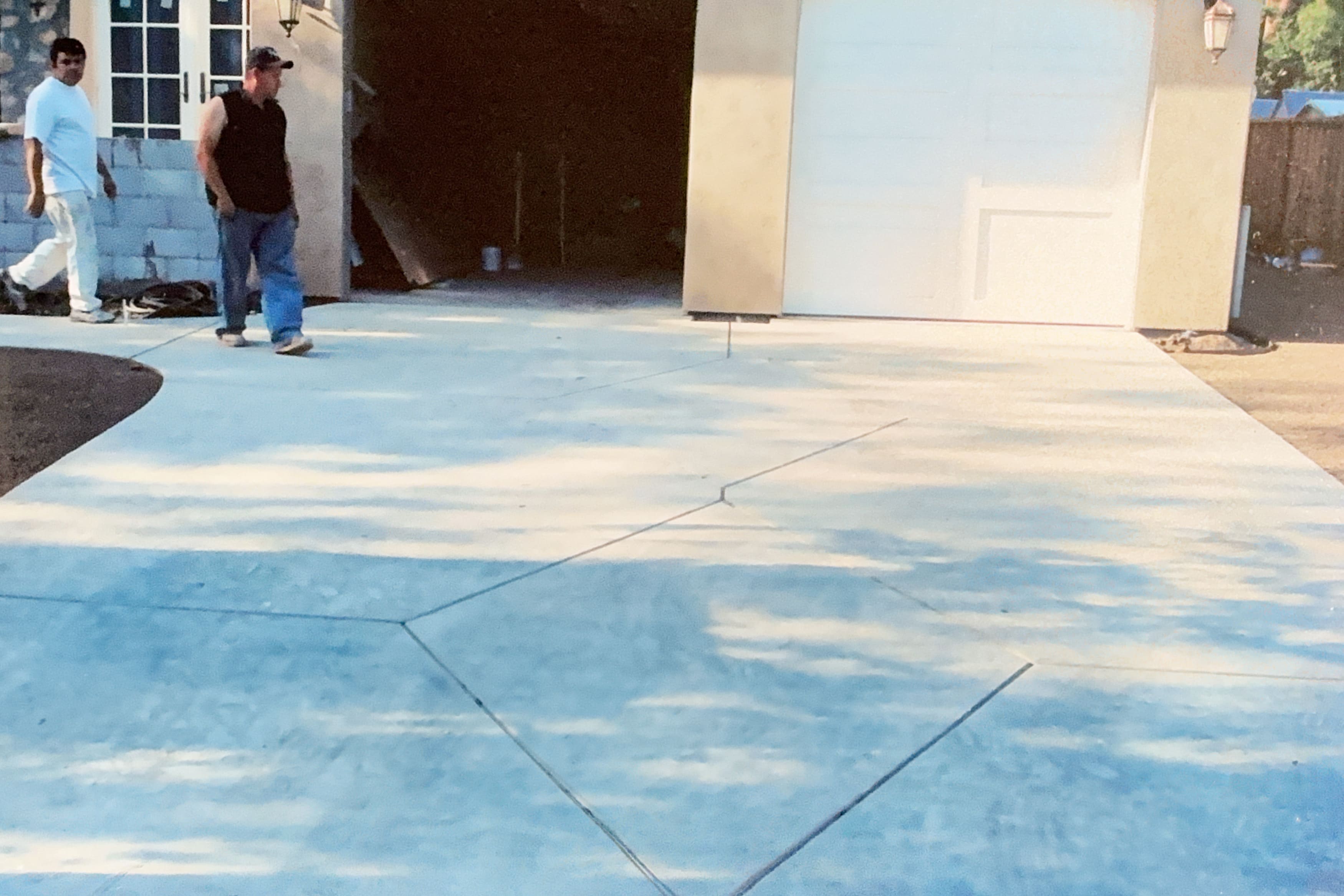 Large newly poured concrete driveway with diamond scoring pattern