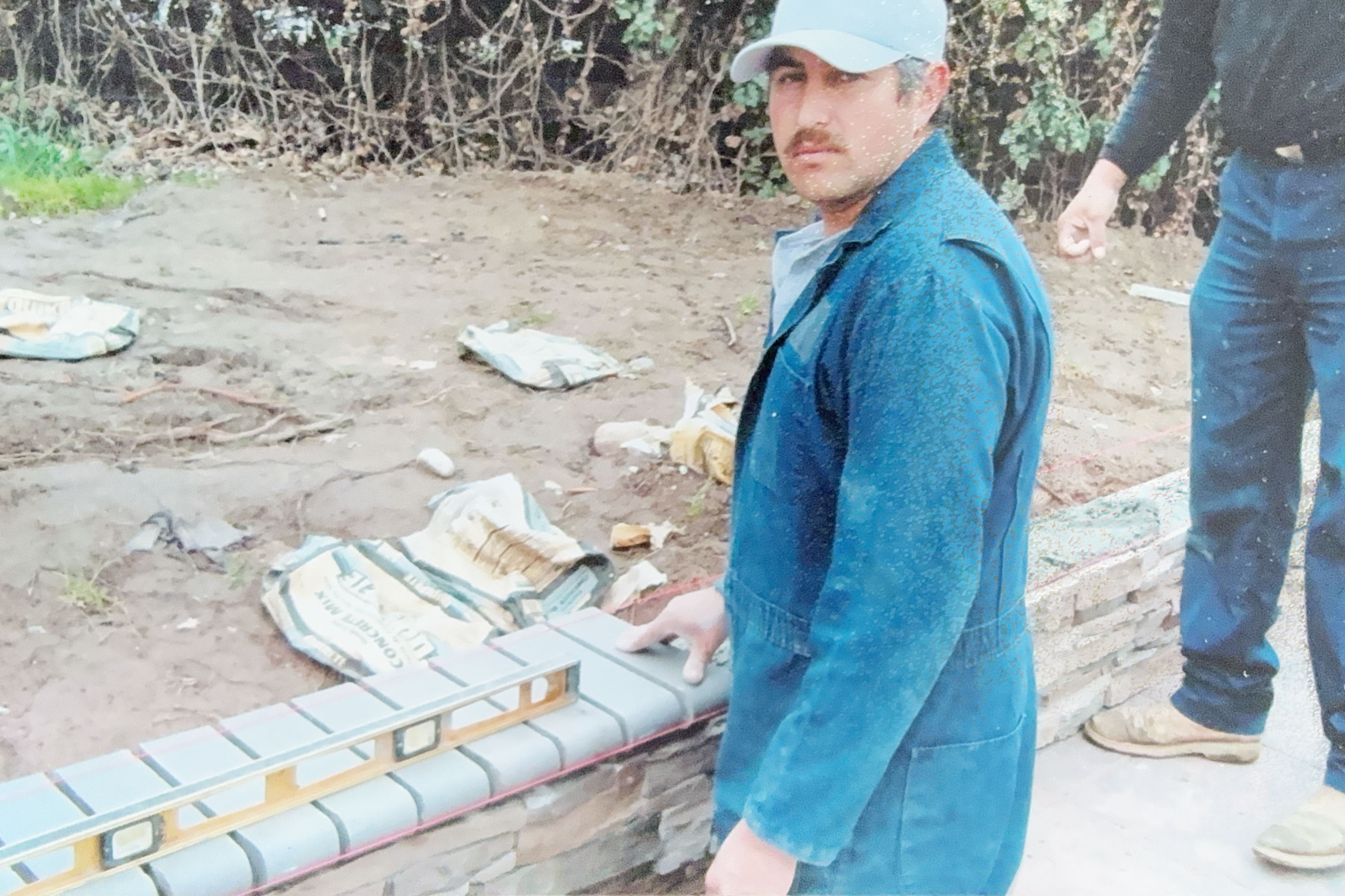 Worker building a decorative stone retaining wall