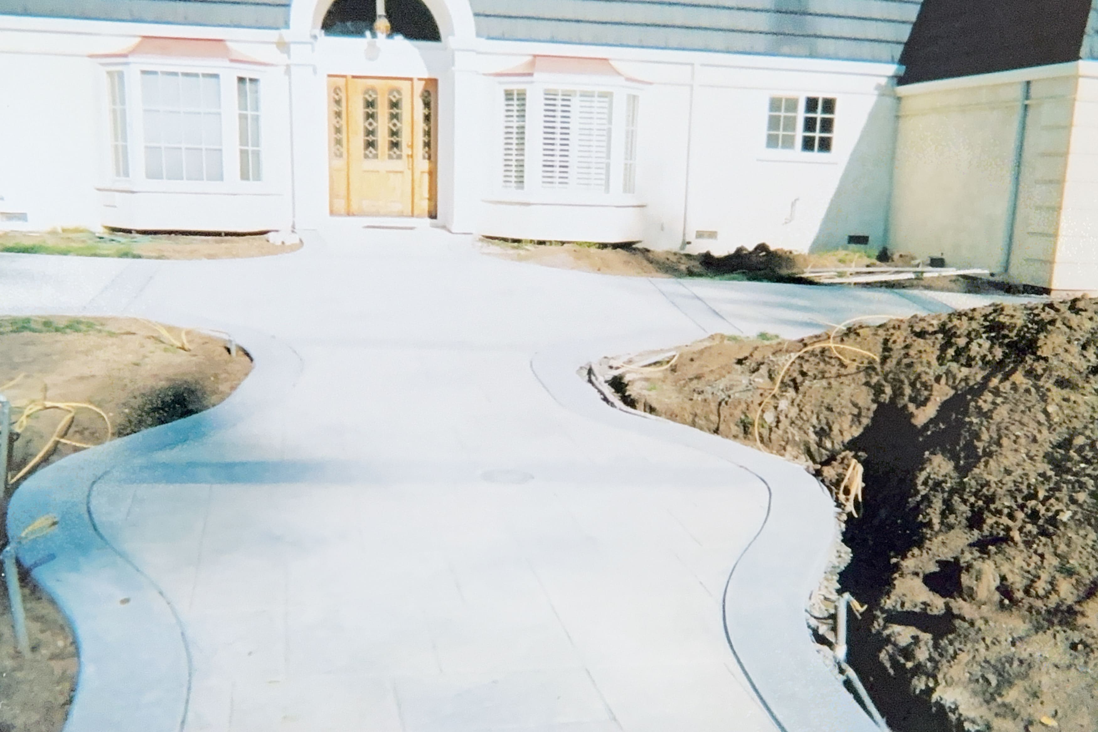 Newly poured concrete pathway leading to front entrance