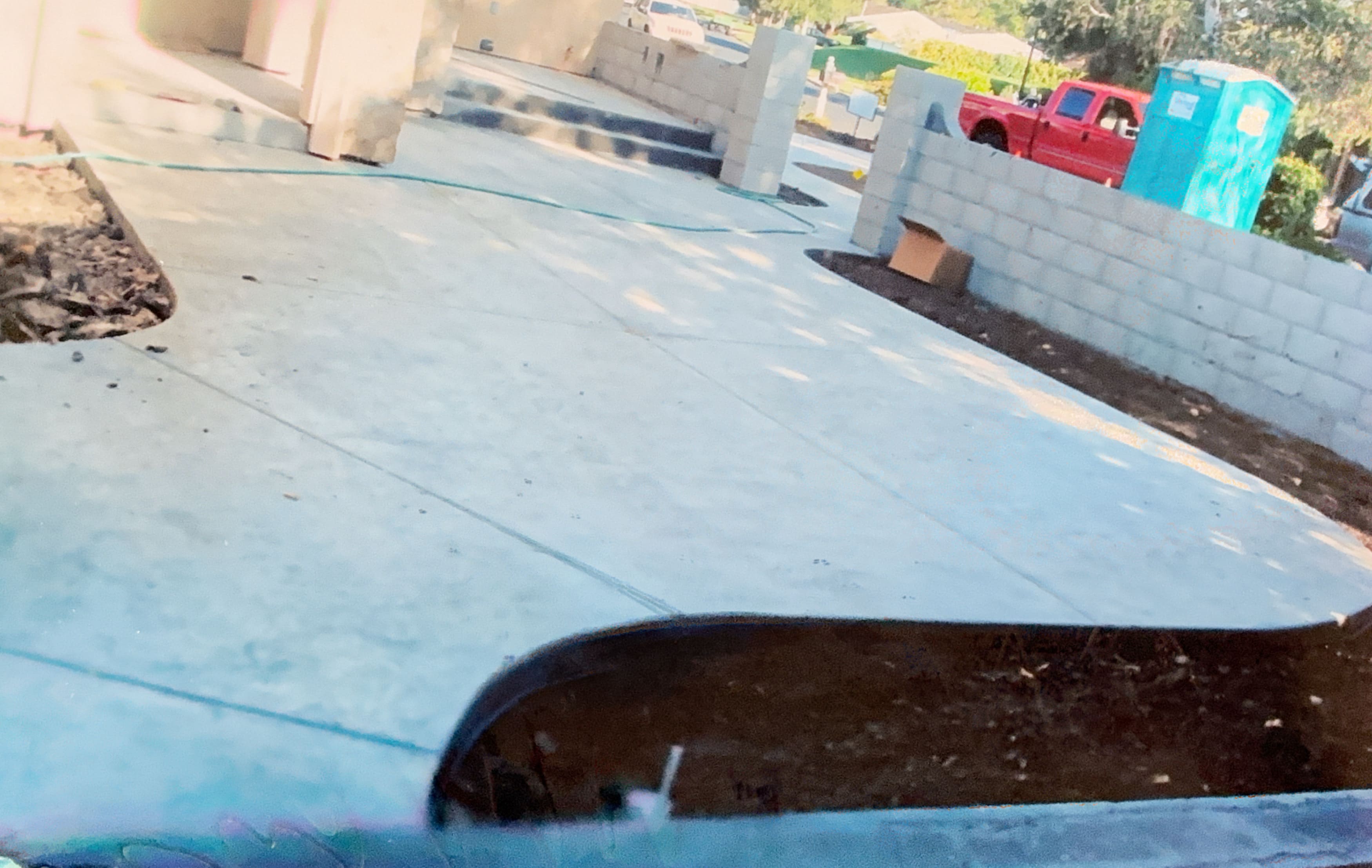 Concrete pathway under construction with cinder block retaining walls