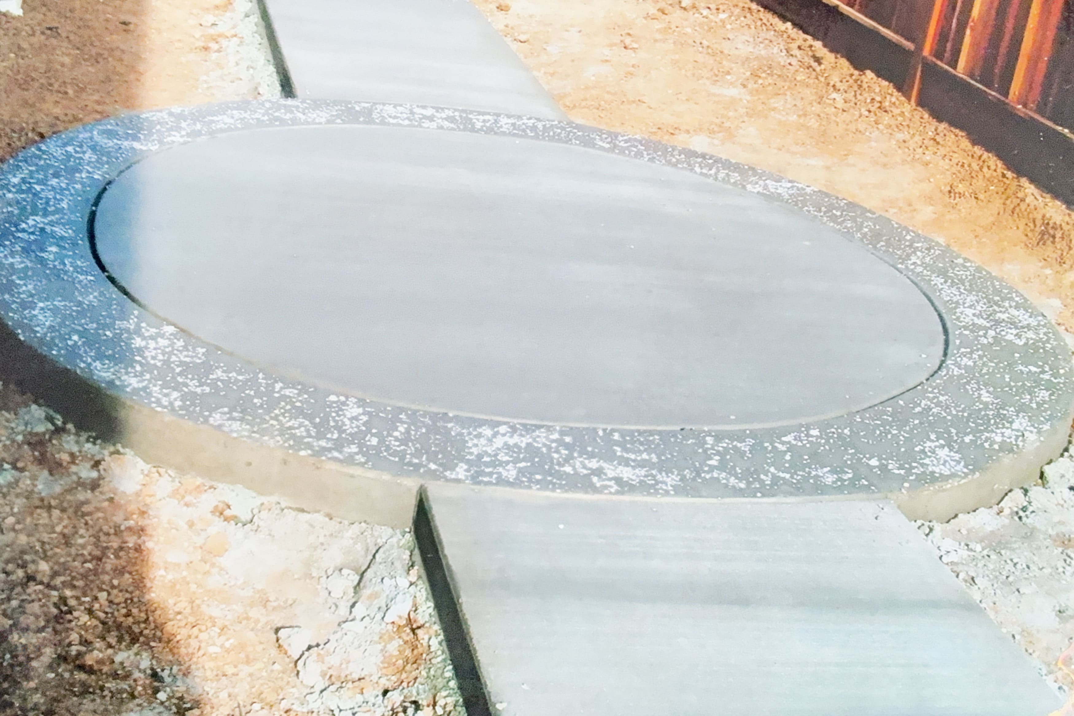Circular concrete pad under construction with connecting walkways