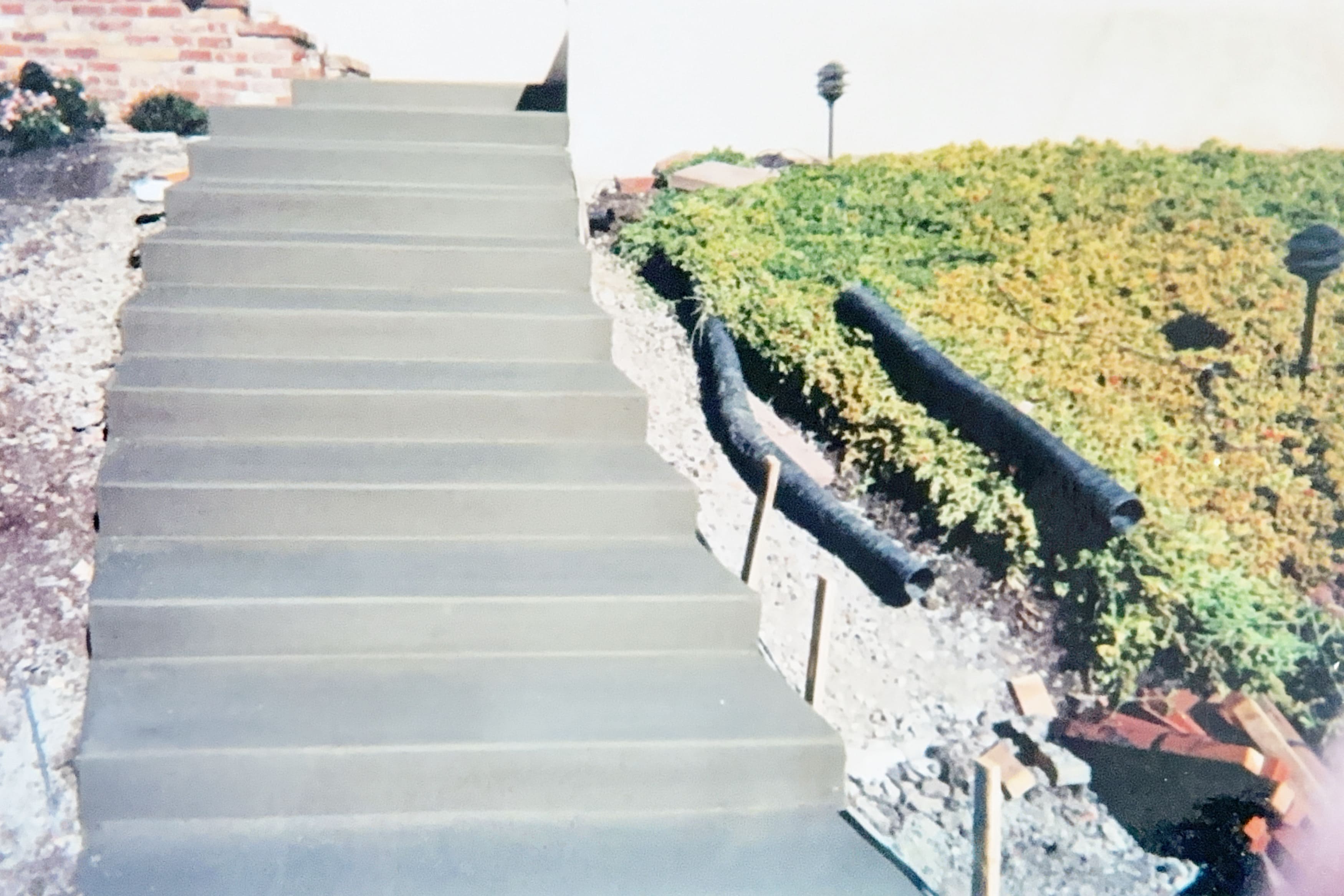 Concrete stairs leading up alongside a landscaped area