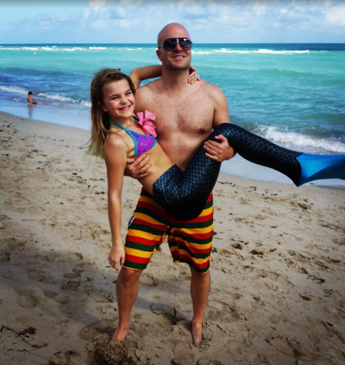Micah and his daughter at the beach