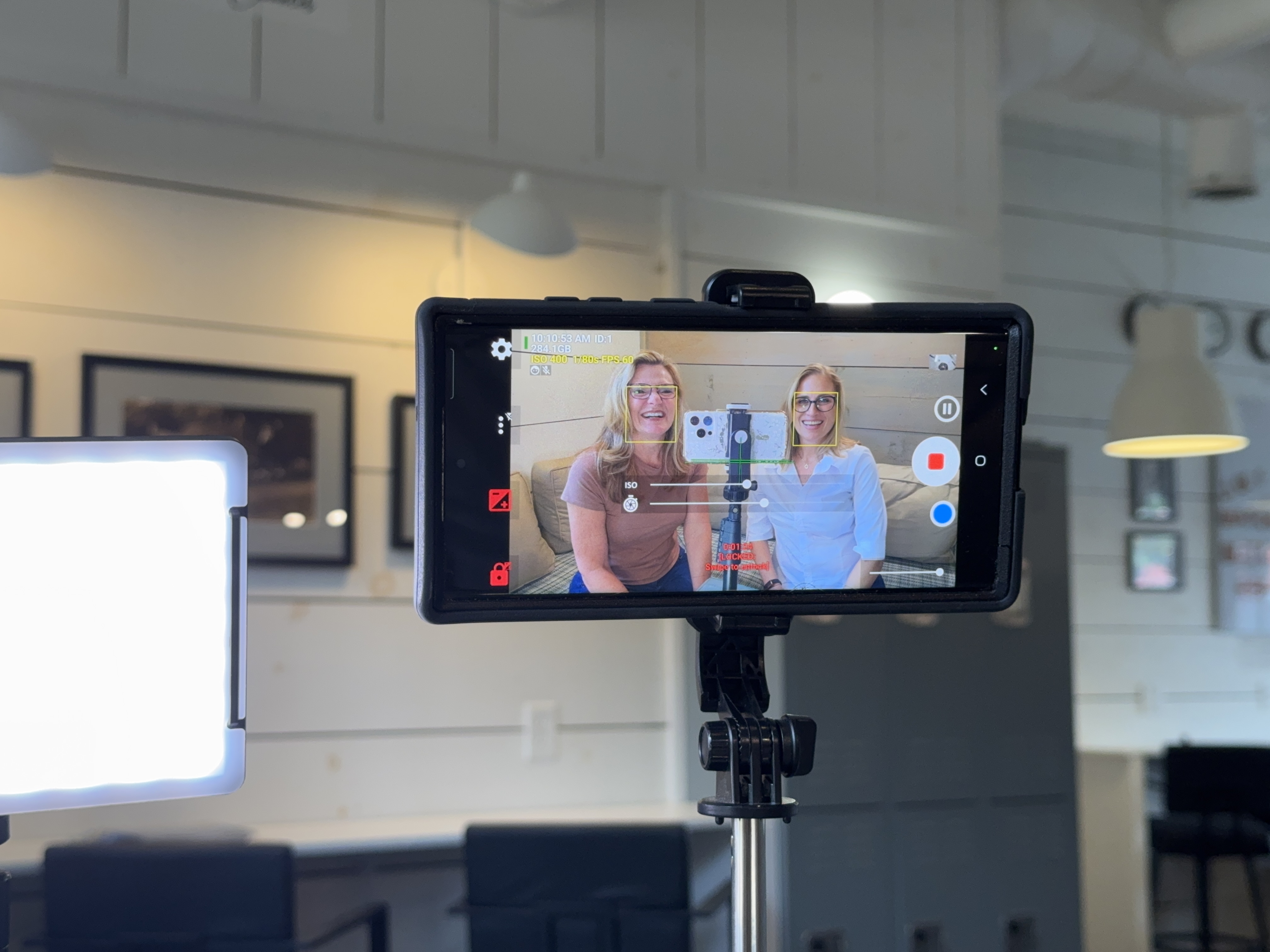 Sharon and Tiffany filming video content behind the scenes with phone rig