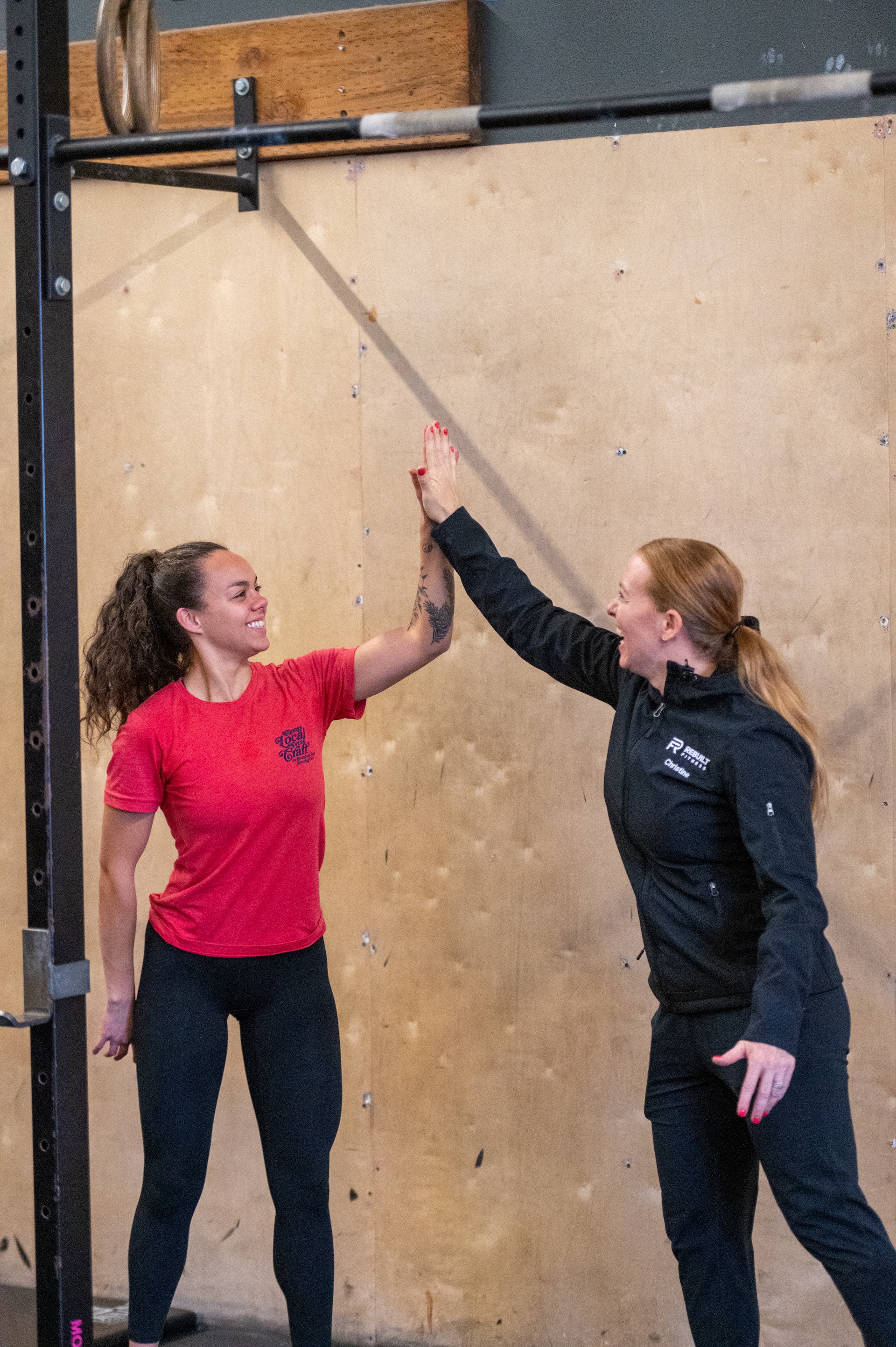 Members high fiving at Rebuilt Fitness