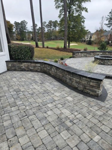 Curved seating walls and stone stairways overlooking Brier Creek Country Club golf course