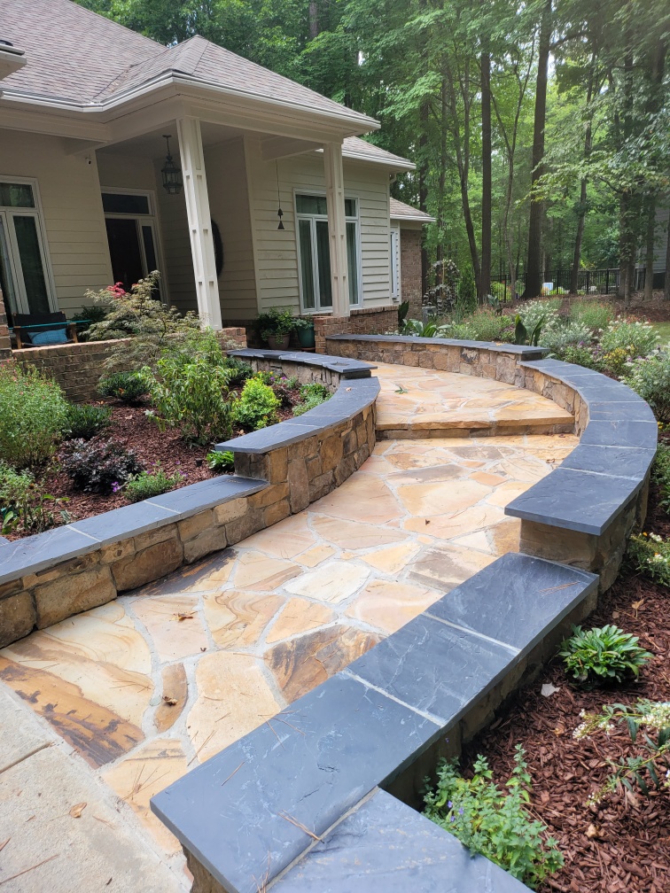 Beautifully landscaped residential yard with curved flagstone walkway