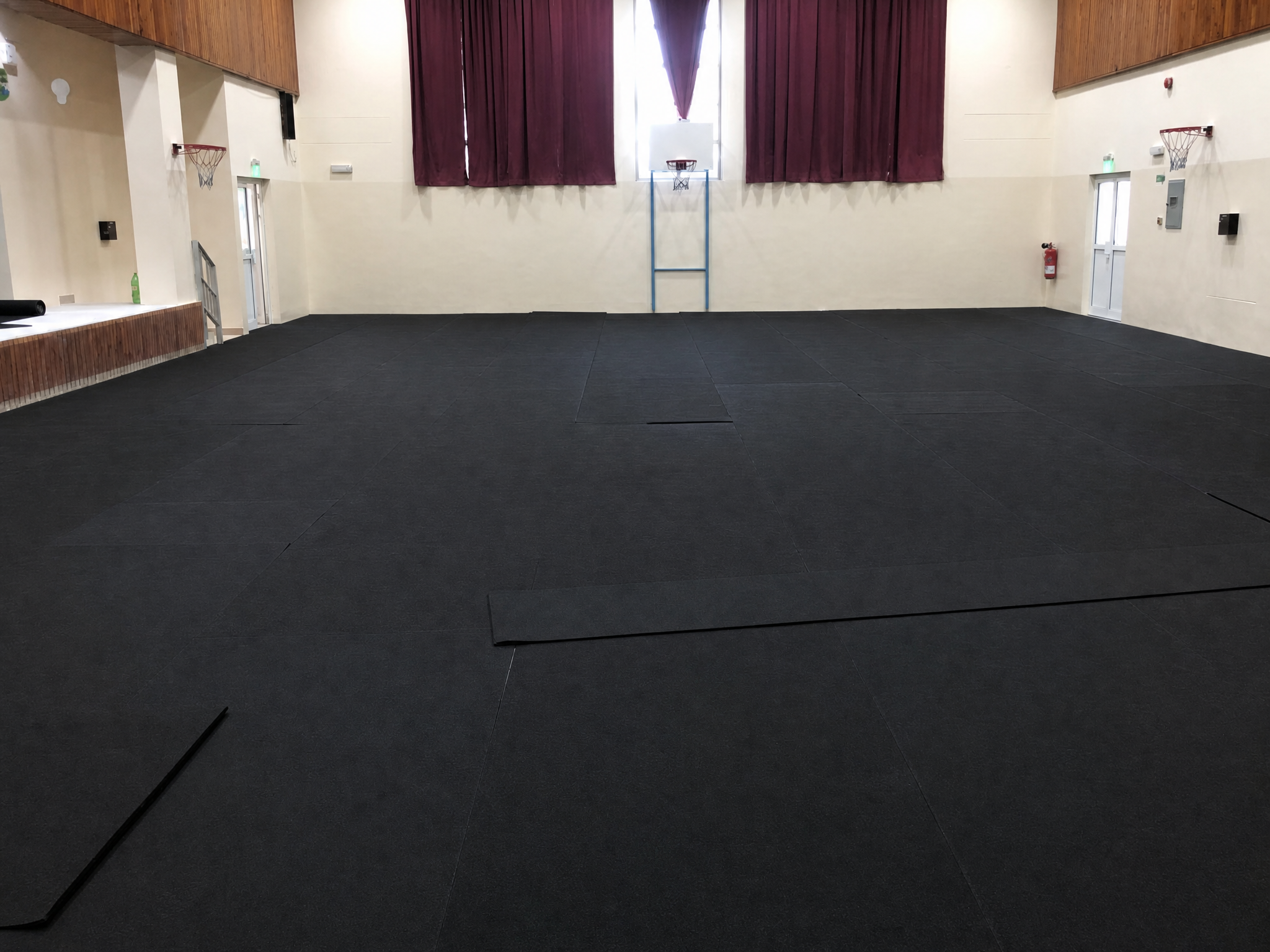 Black rubber shock absorption layer installed on sports hall floor