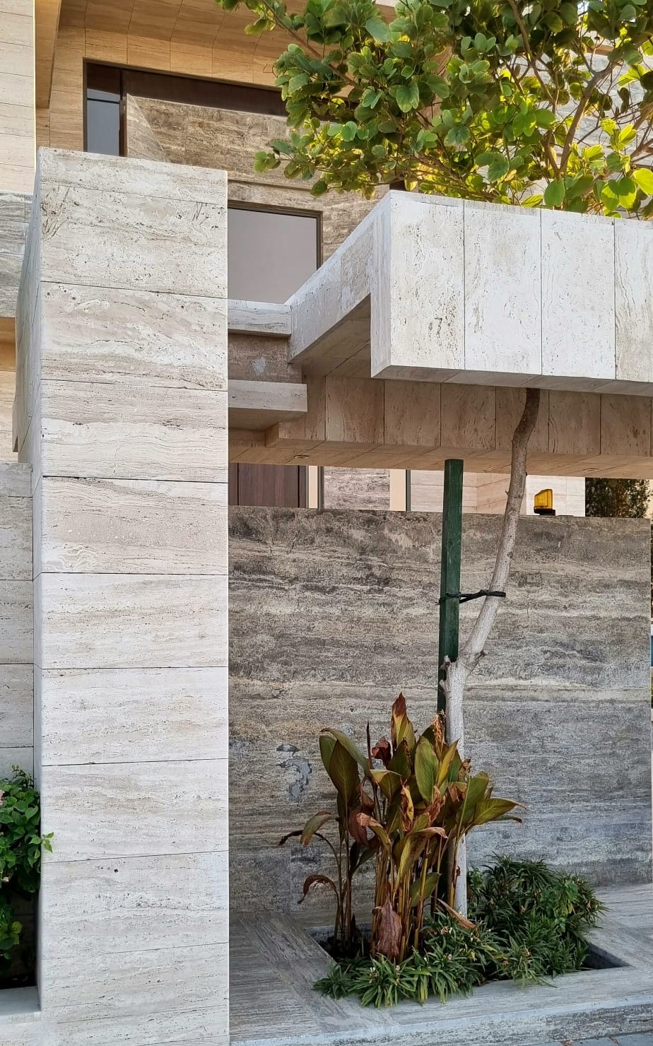 Travertine facade detail showing natural veining and slab alignment