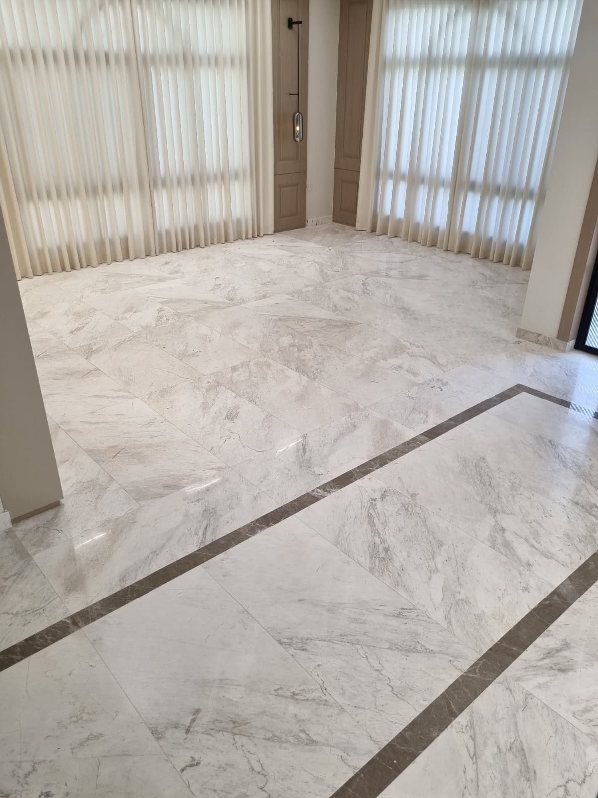 Marble floor with decorative border in living area of private residence