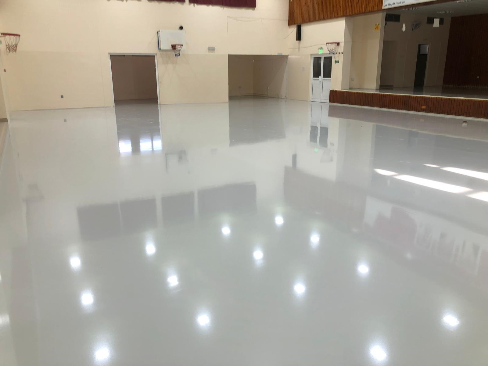 Glossy PU top coat finish applied on school gymnasium floor