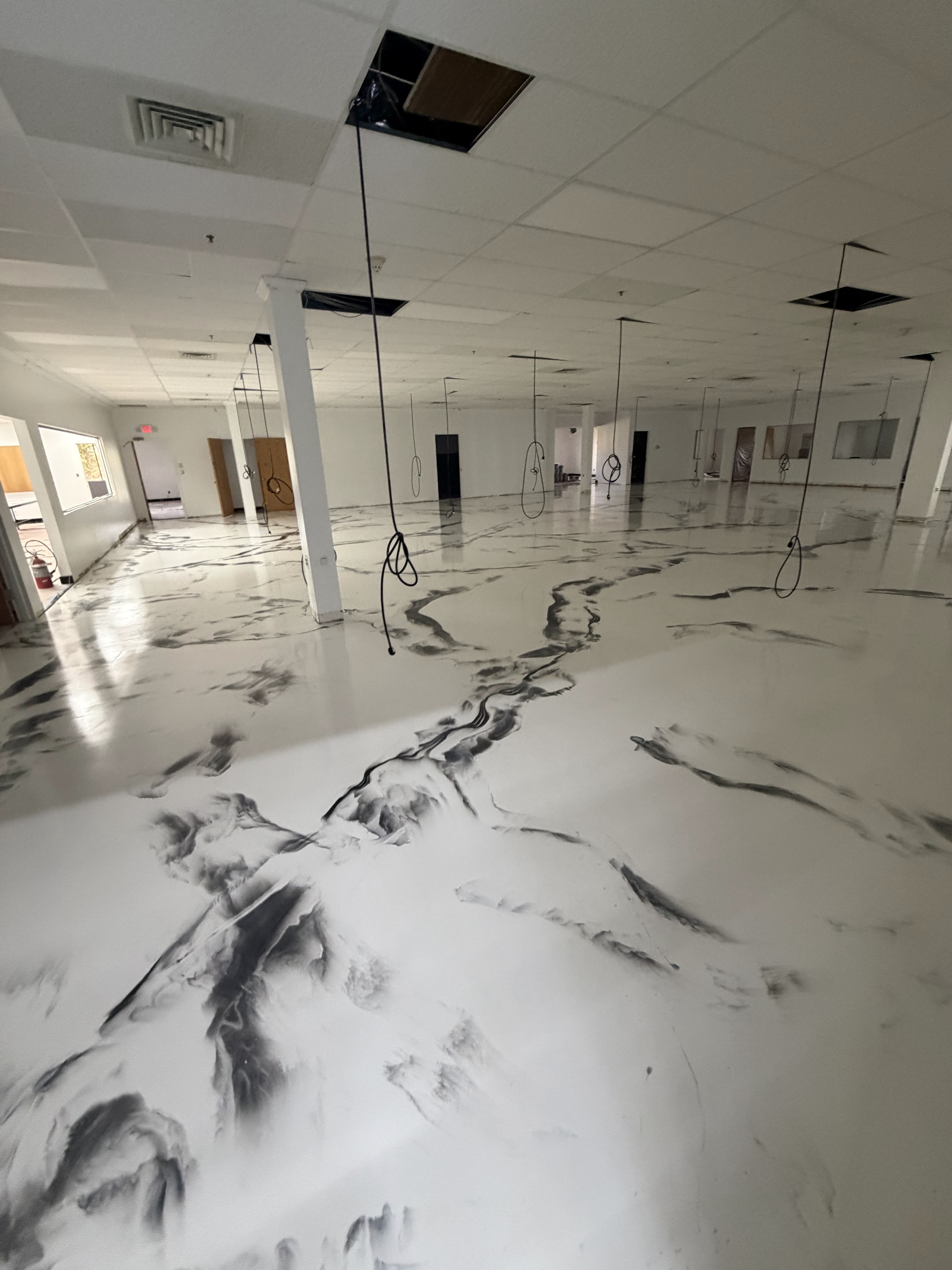 Large commercial space with custom metallic epoxy floor