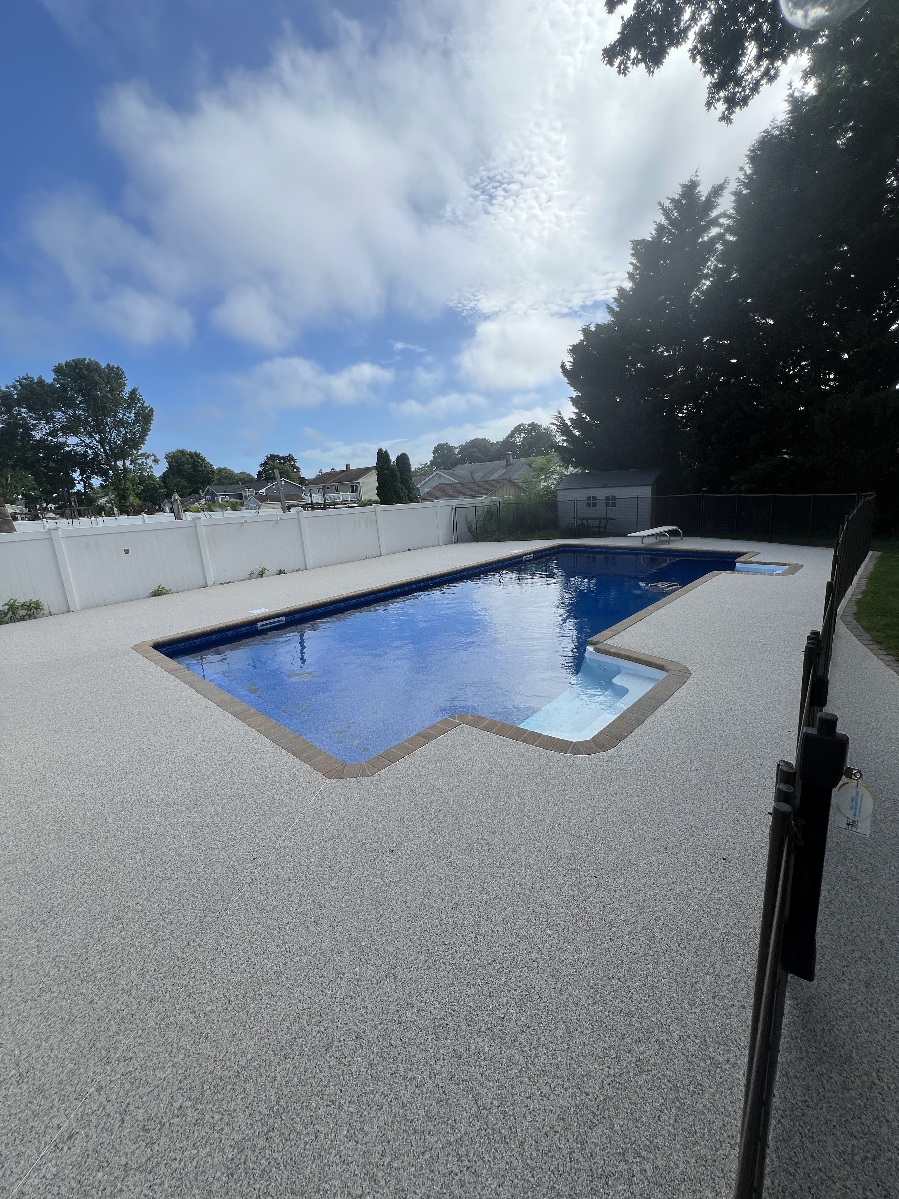 Outdoor pool deck with slip-resistant textured coating