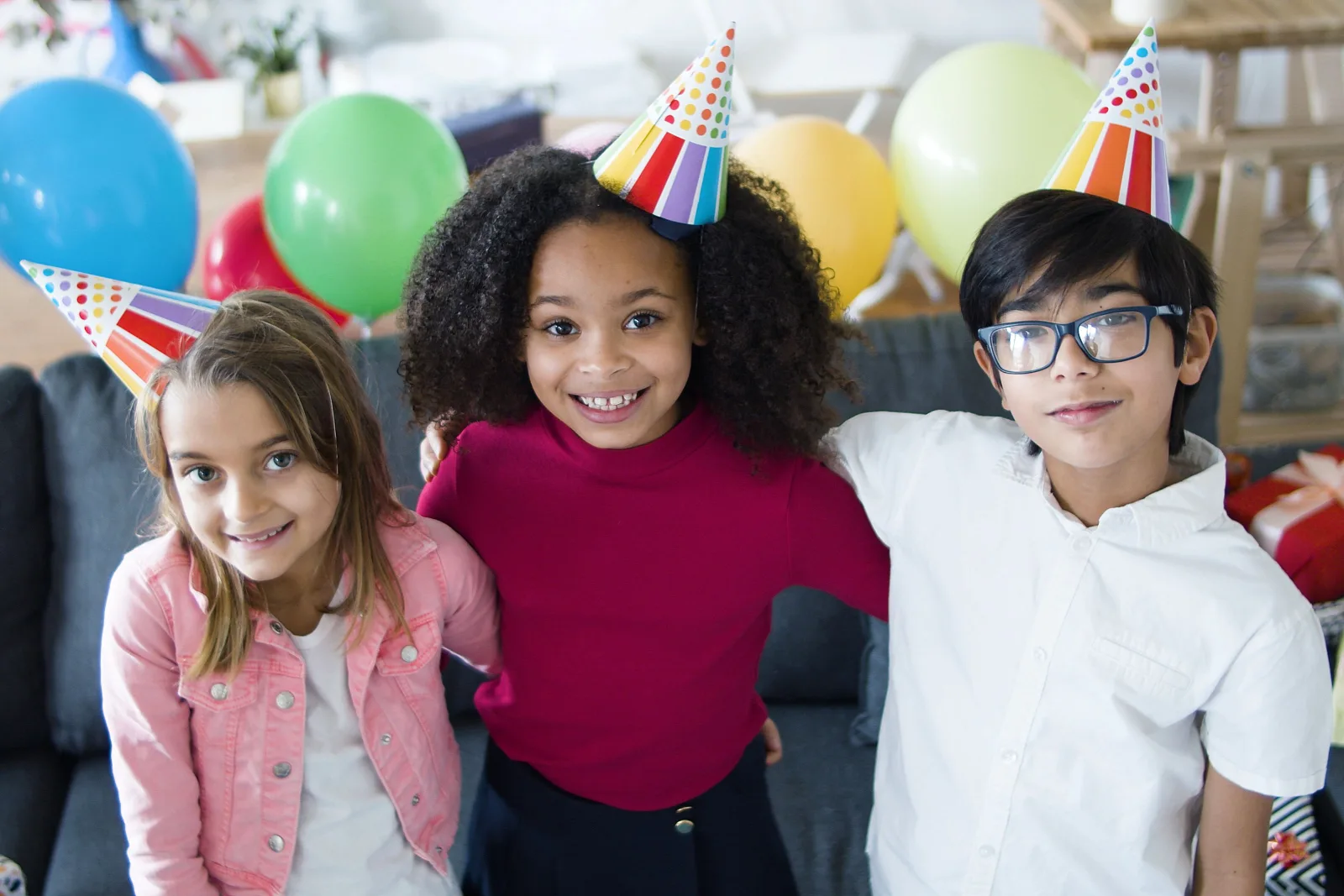 Children in party hats celebrating at a birthday party