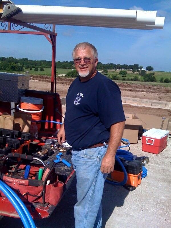 Service Plumbing craftsman at the truck bed — built on a handshake since 1950