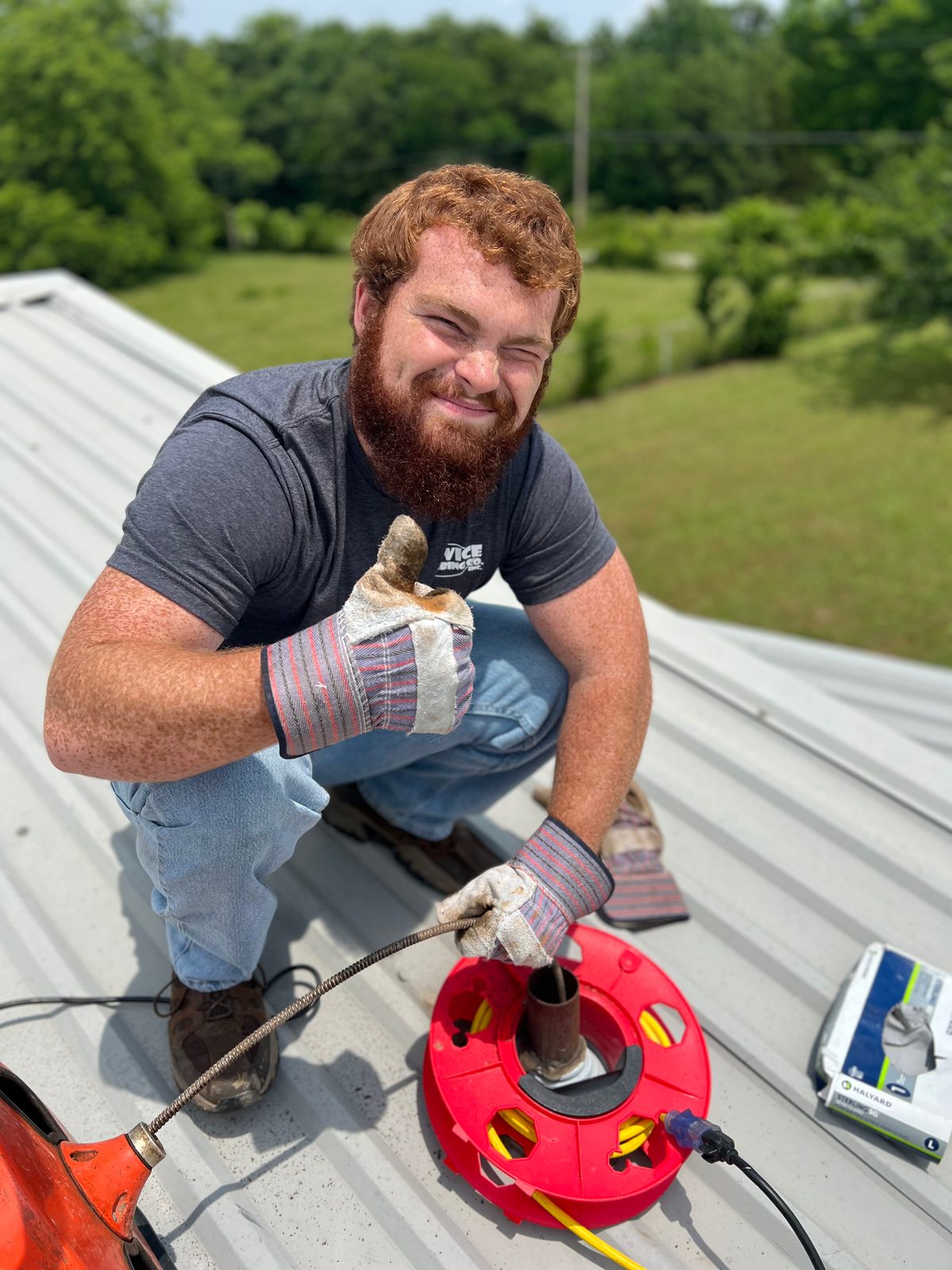 Service Plumbing technician snaking a roof vent stack