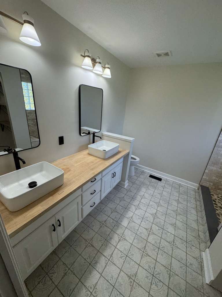Bathroom remodel with glass enclosure by A Kingdom Construction Co.